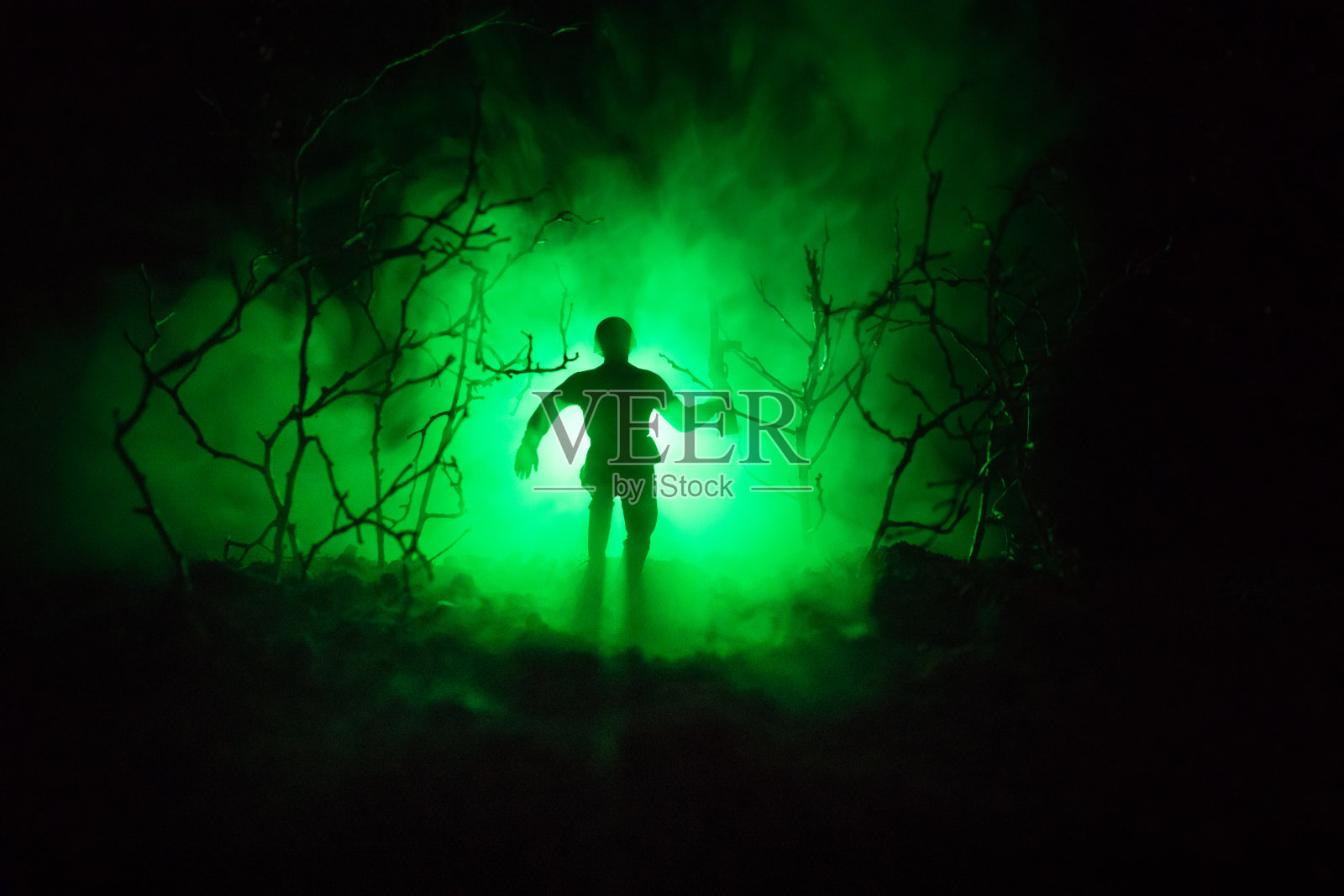 在战斗中，士兵的黑色剪影在燃烧的浓烟中移动。回光。健美的照片摄影图片