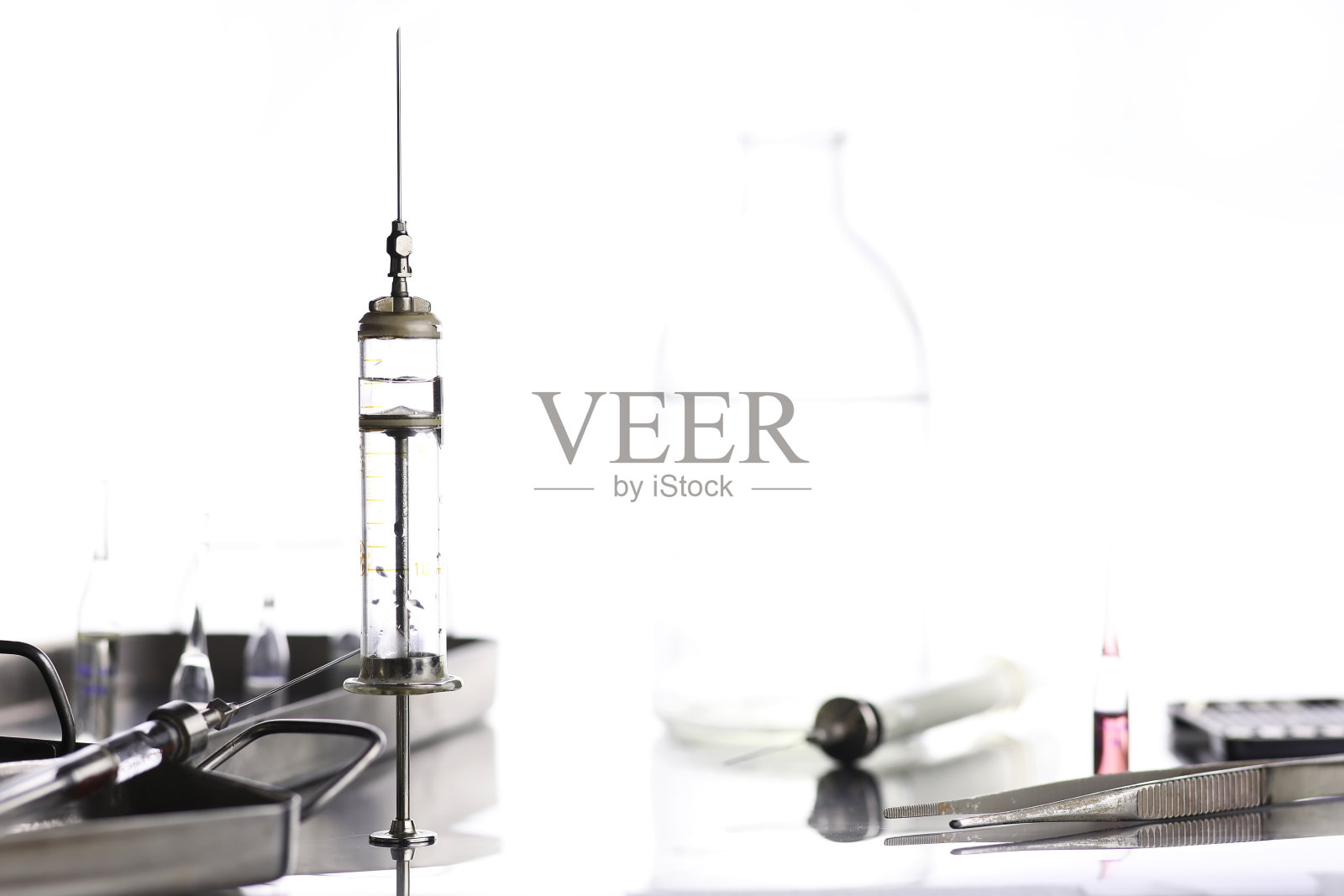 桌子上的老旧金属医用注射器和配件照片摄影图片