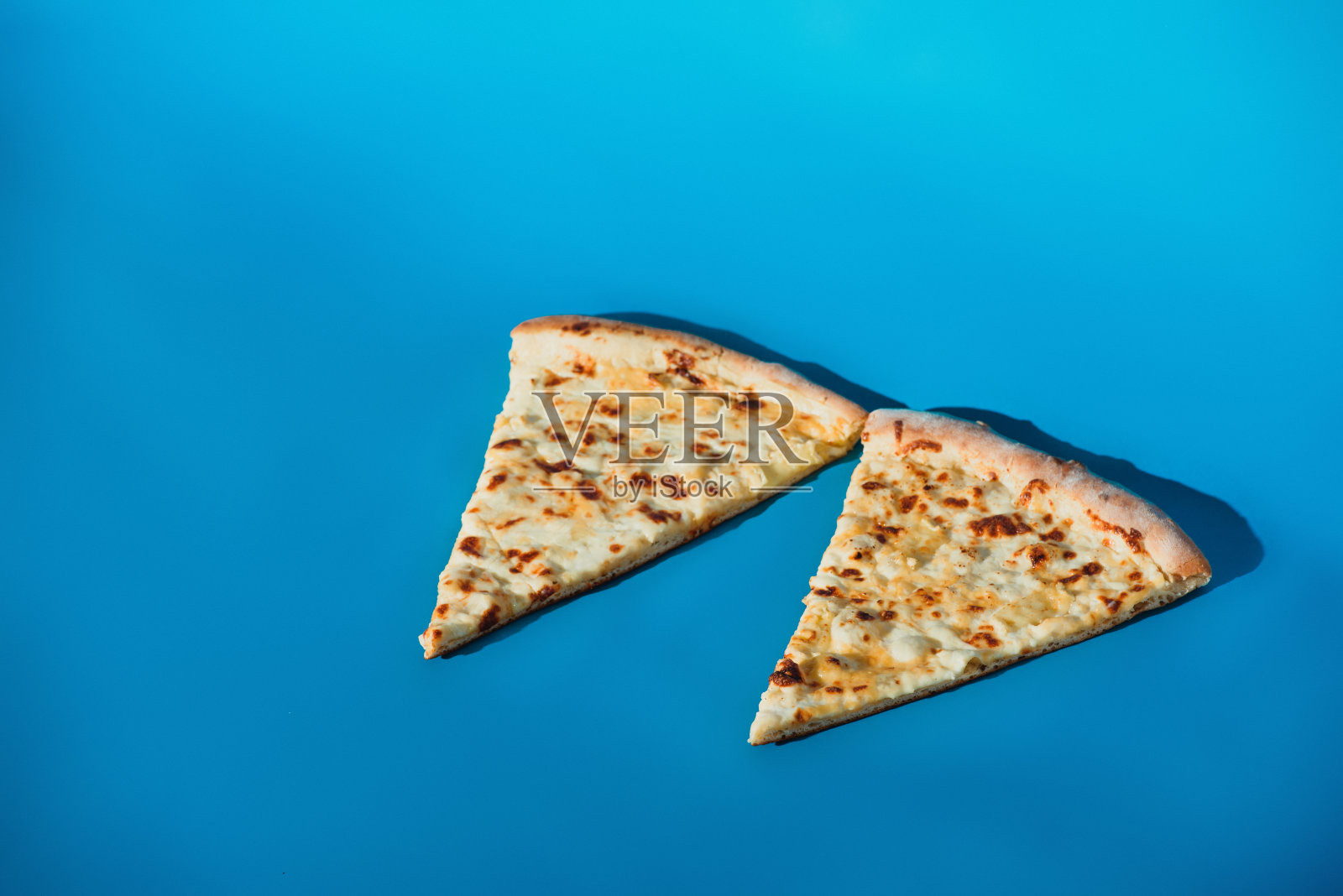 近距离观察一块块熟比萨饼孤立在蓝色照片摄影图片