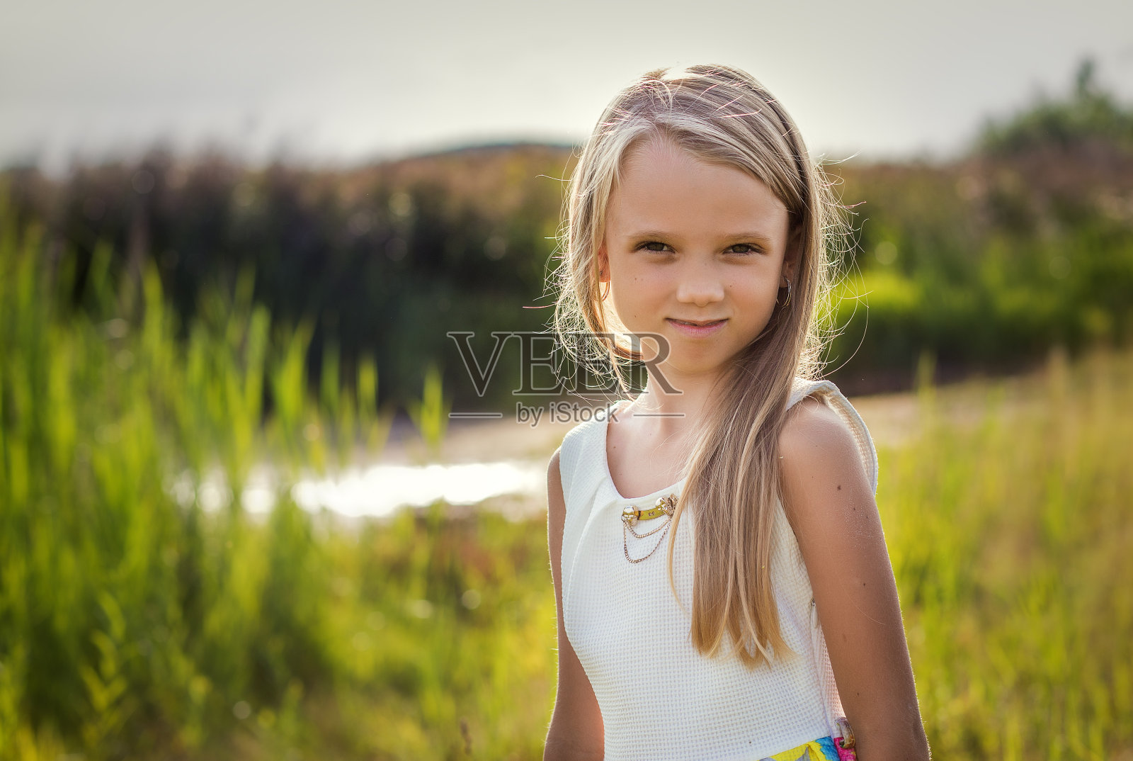 一个美丽的长头发小女孩的肖像，在户外照片摄影图片