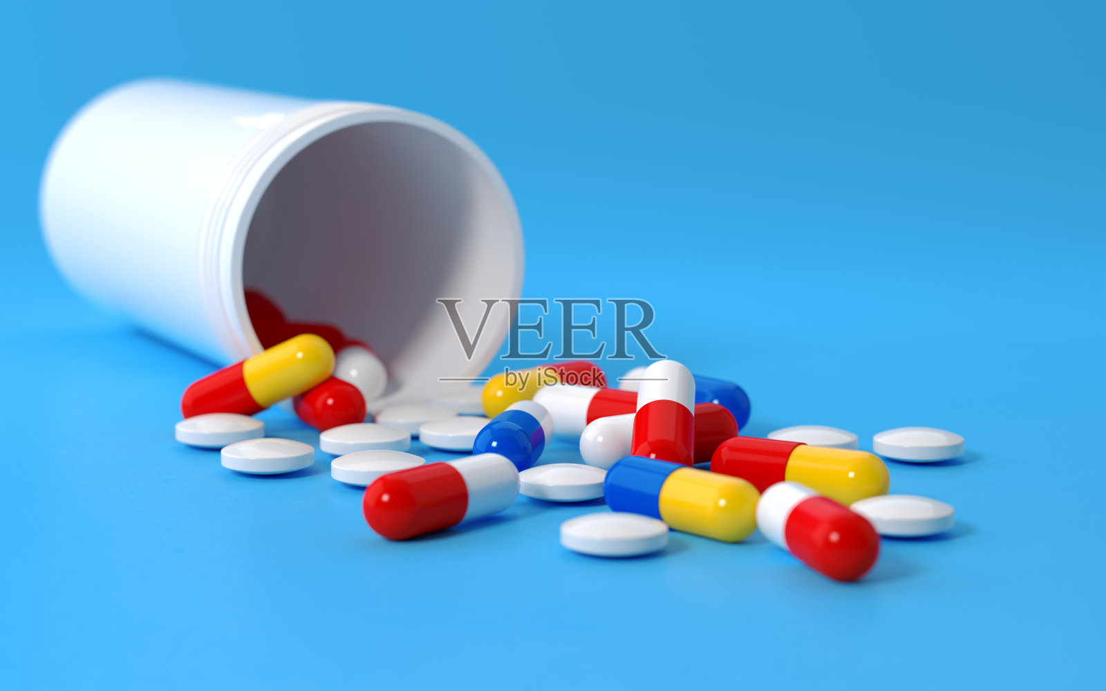 药丸盒子和彩色药丸在蓝色的背景照片摄影图片