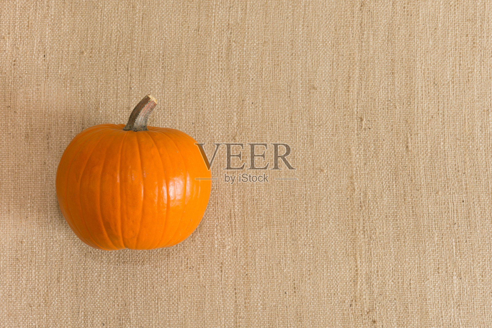 一个成熟的糖南瓜，米色背景照片摄影图片