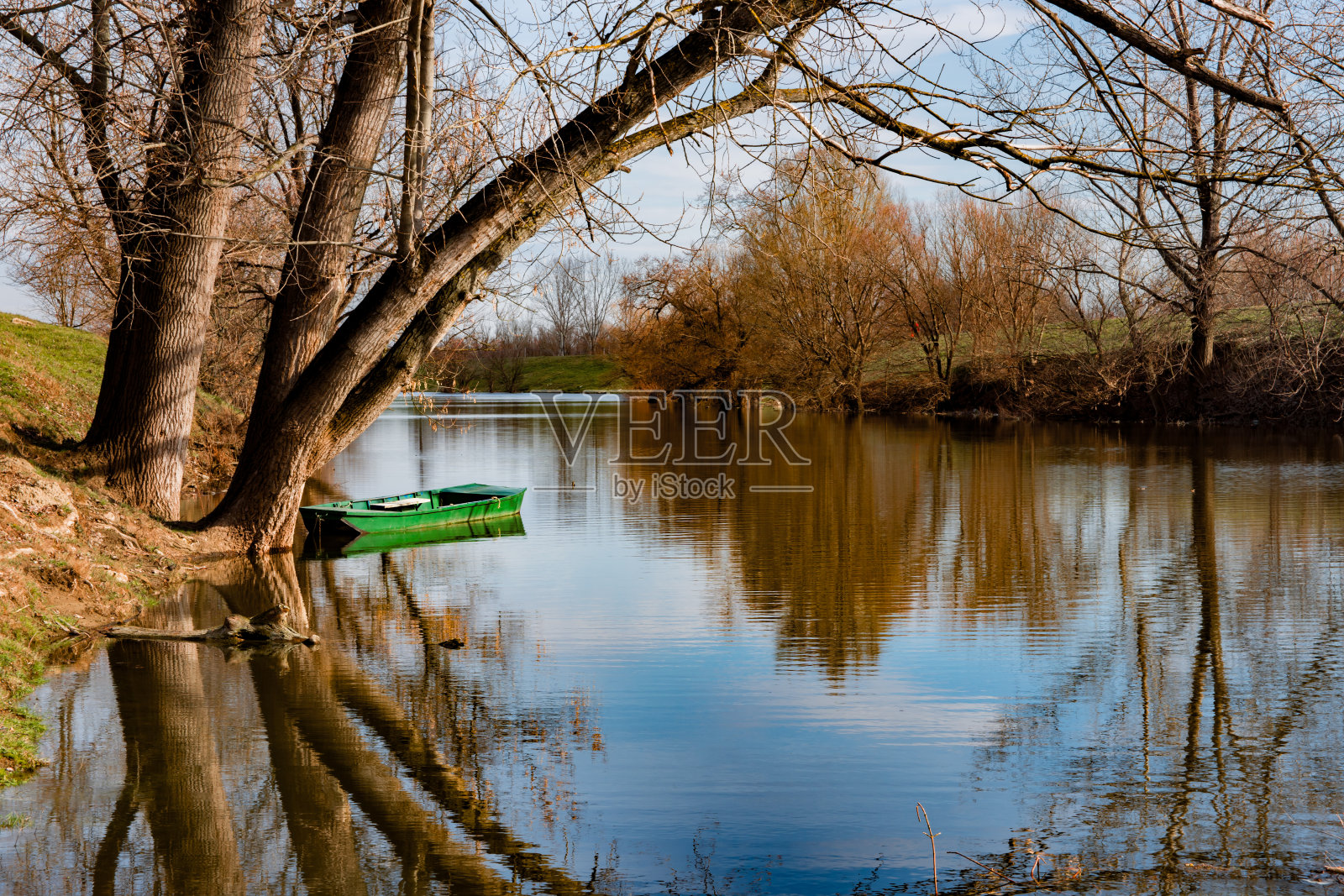 多瑙河上美丽的森林在水中反射着秋天的色彩，还有小船。塞尔维亚纳黛尔，伊万诺卡·阿达照片摄影图片