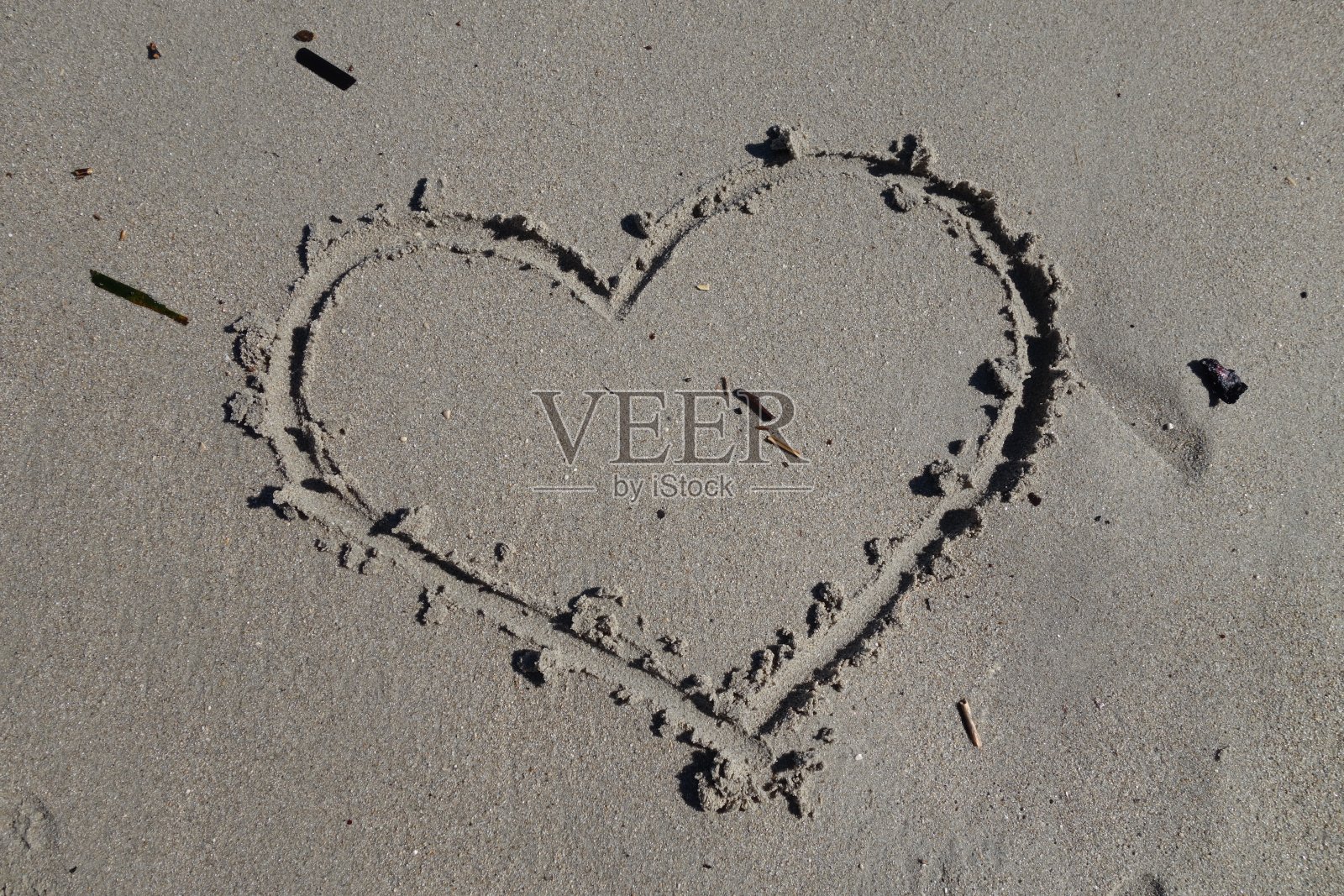 在沙滩上的沙子上画的心照片摄影图片