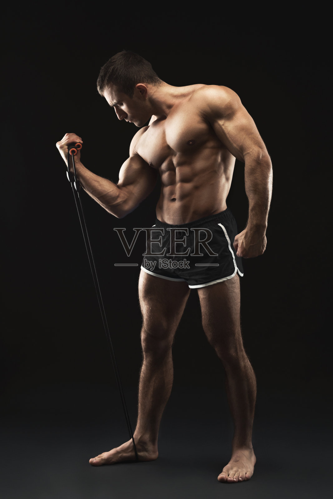 运动肌肉男子在黑色与弹性扩张运动照片摄影图片