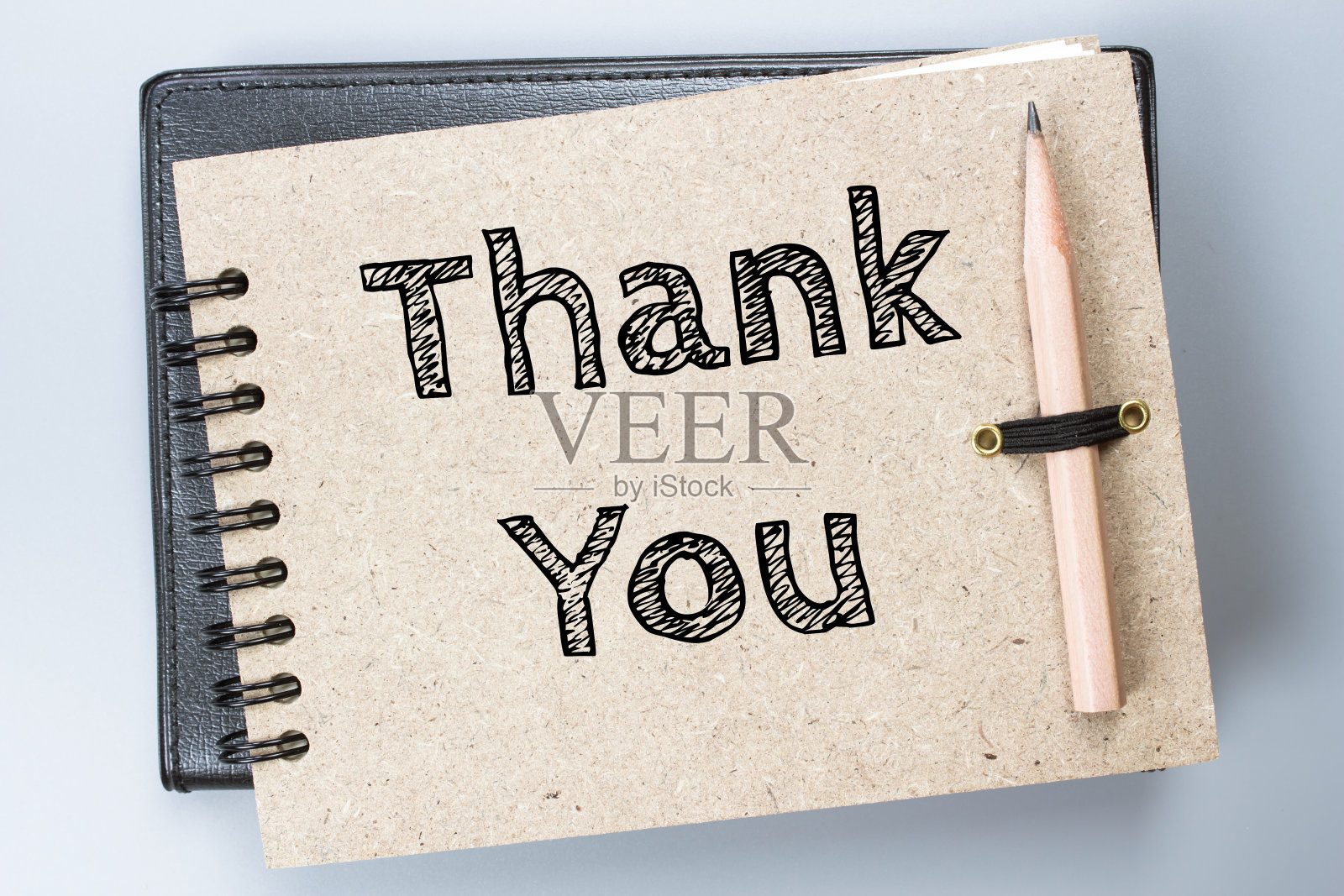 谢谢你，关于棕色笔记本/商业概念的短信照片摄影图片