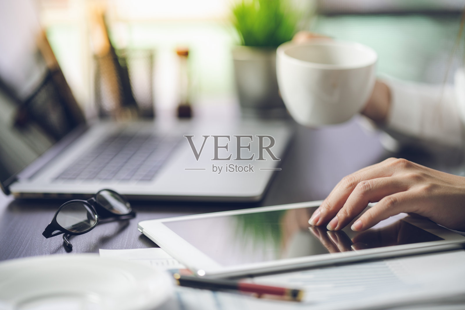 商人在办公室里一边喝咖啡一边处理文件照片摄影图片