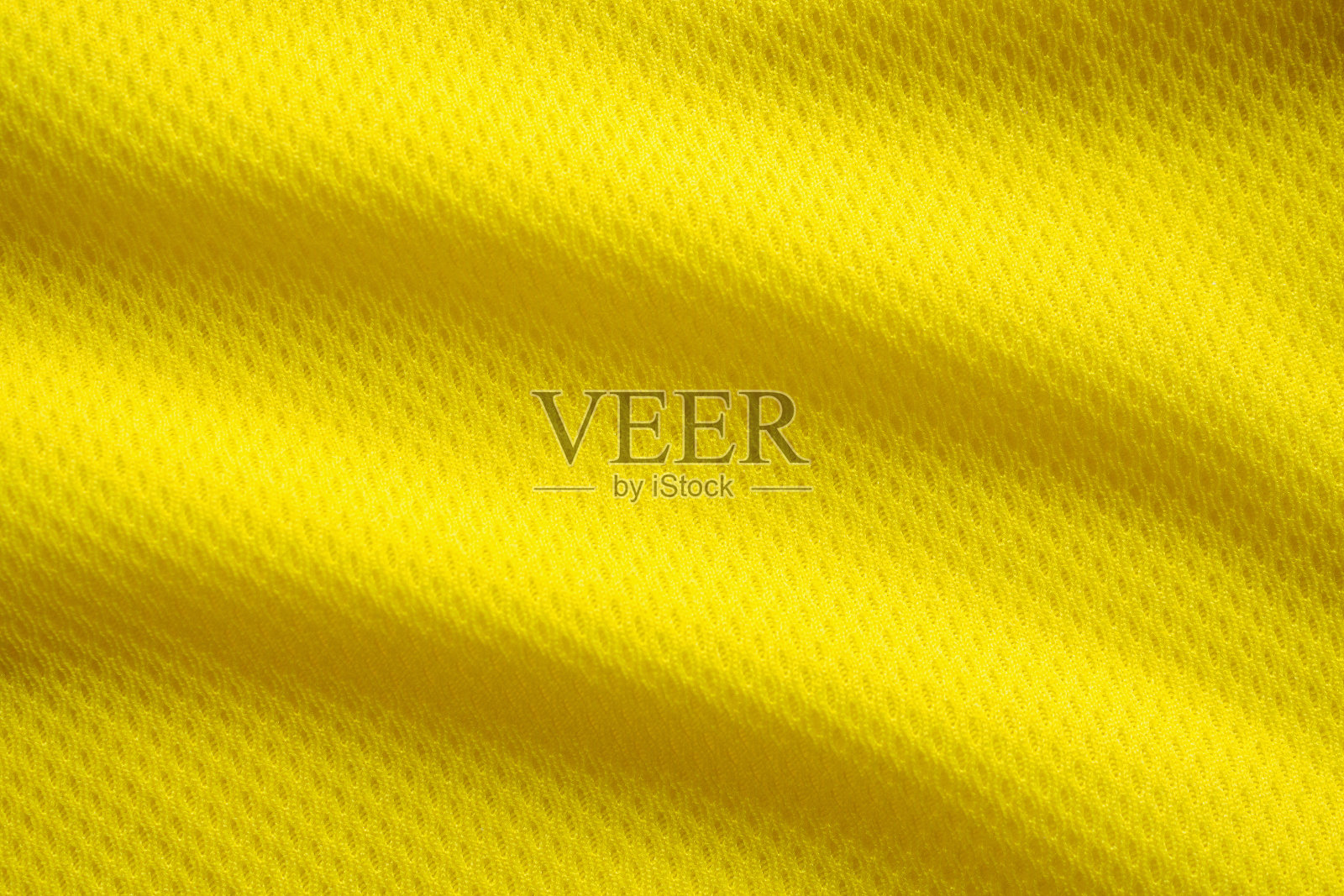 黄色足球运动服面料质地运动服背景，特写照片摄影图片