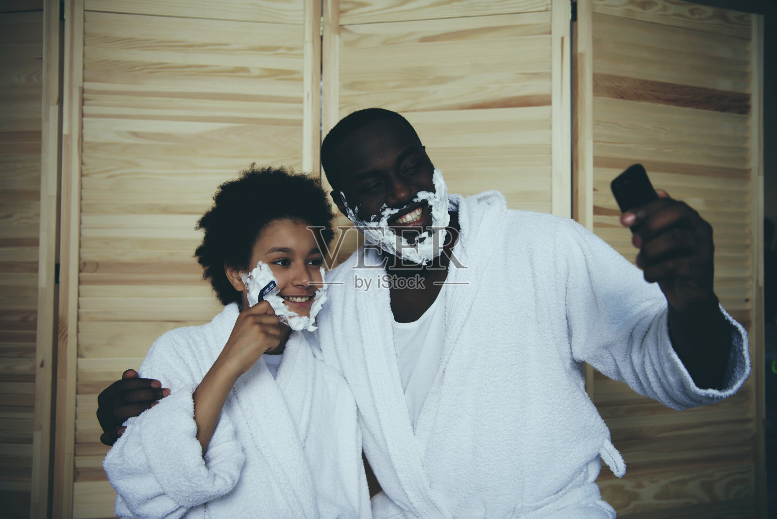 穿着浴衣的美国黑人父亲和小儿子照片摄影图片