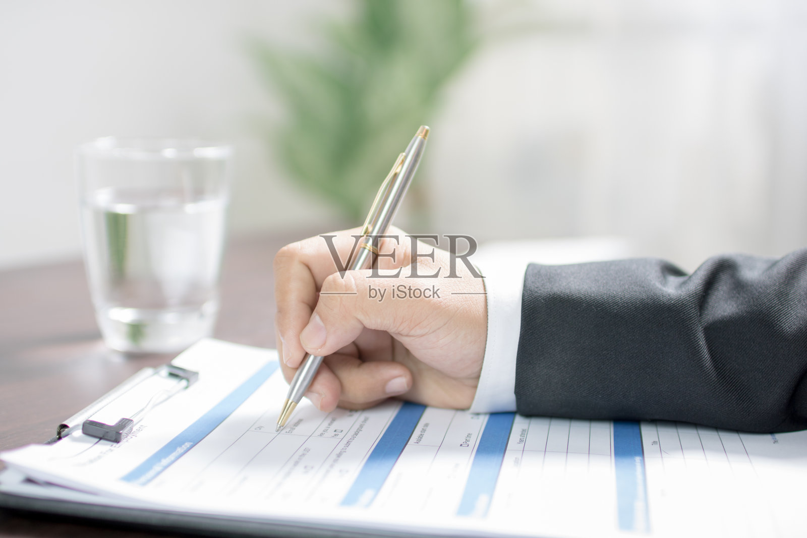 商人在申请表或书面资料上的书写照片摄影图片