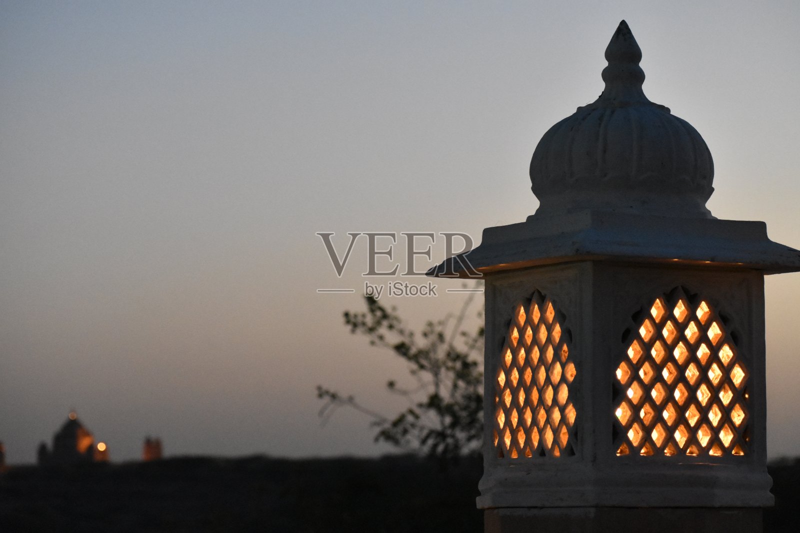 黄昏时的灯柱，背景是一座宫殿照片摄影图片