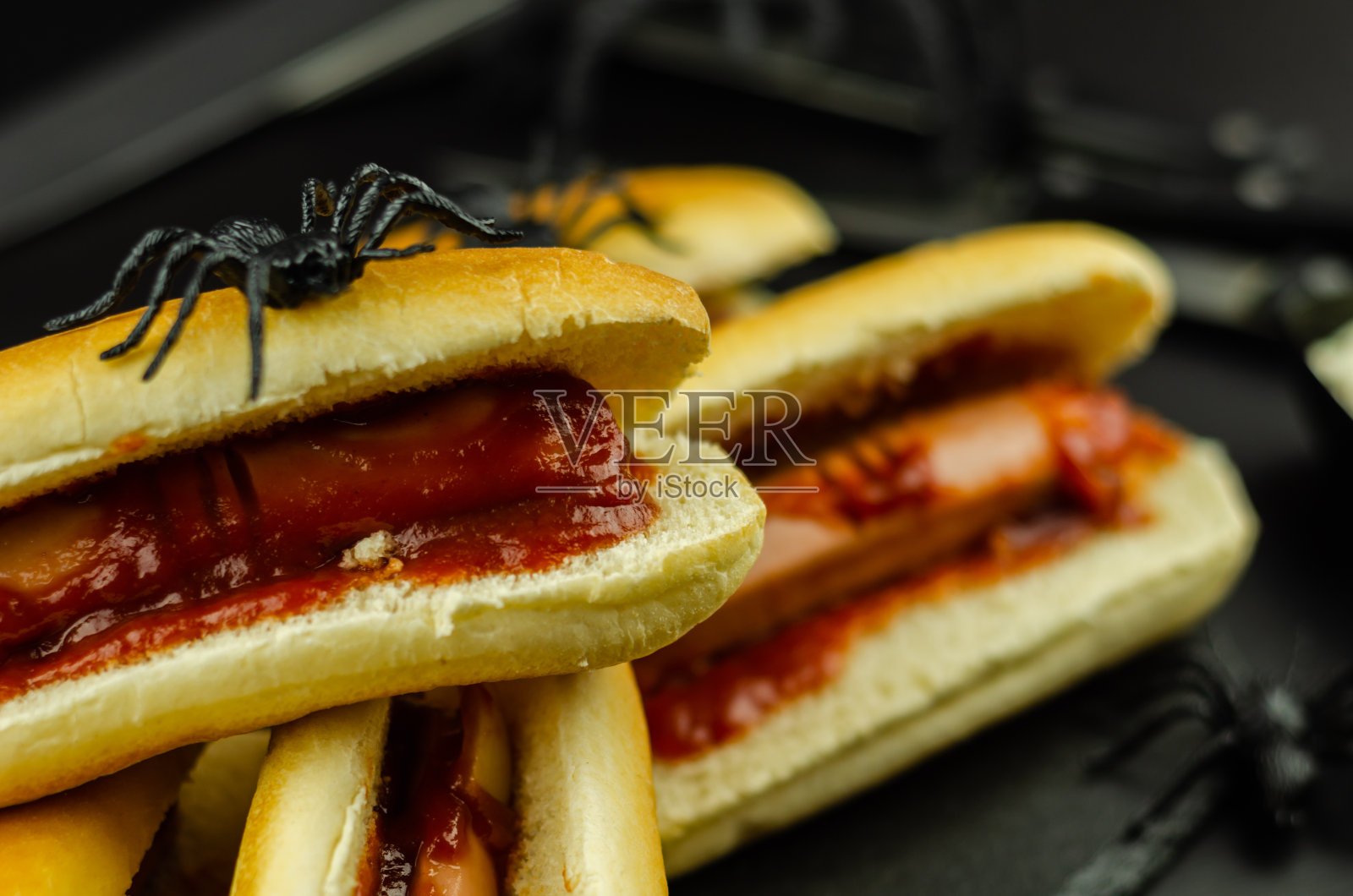 黑色桌子上诡异的万圣节热狗手指照片摄影图片