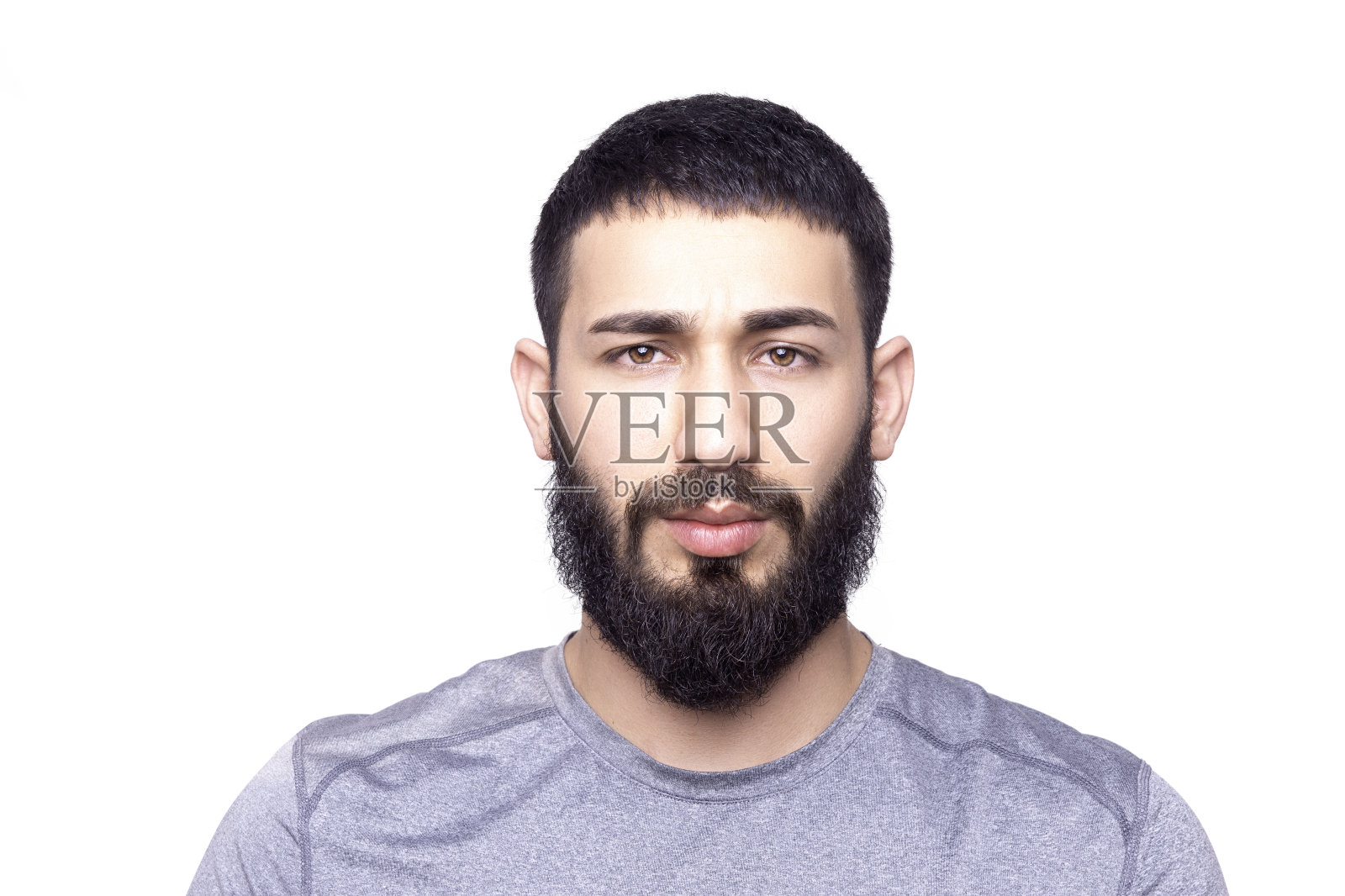 英俊的年轻人的肖像看着相机与空白的面部表情在一个白色的背景照片摄影图片