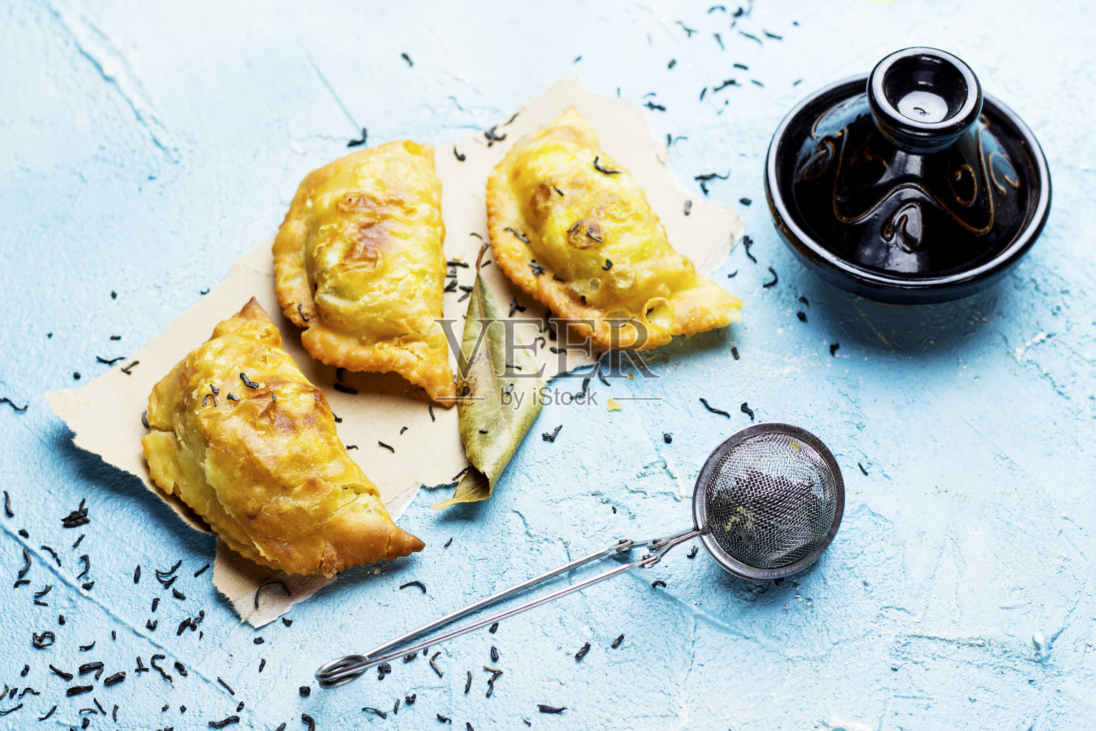 阿尔及利亚的一种肉，纸上的名字叫bourek laajine，用草药和绿色迷迭香装饰的摩洛哥塔吉尼照片摄影图片
