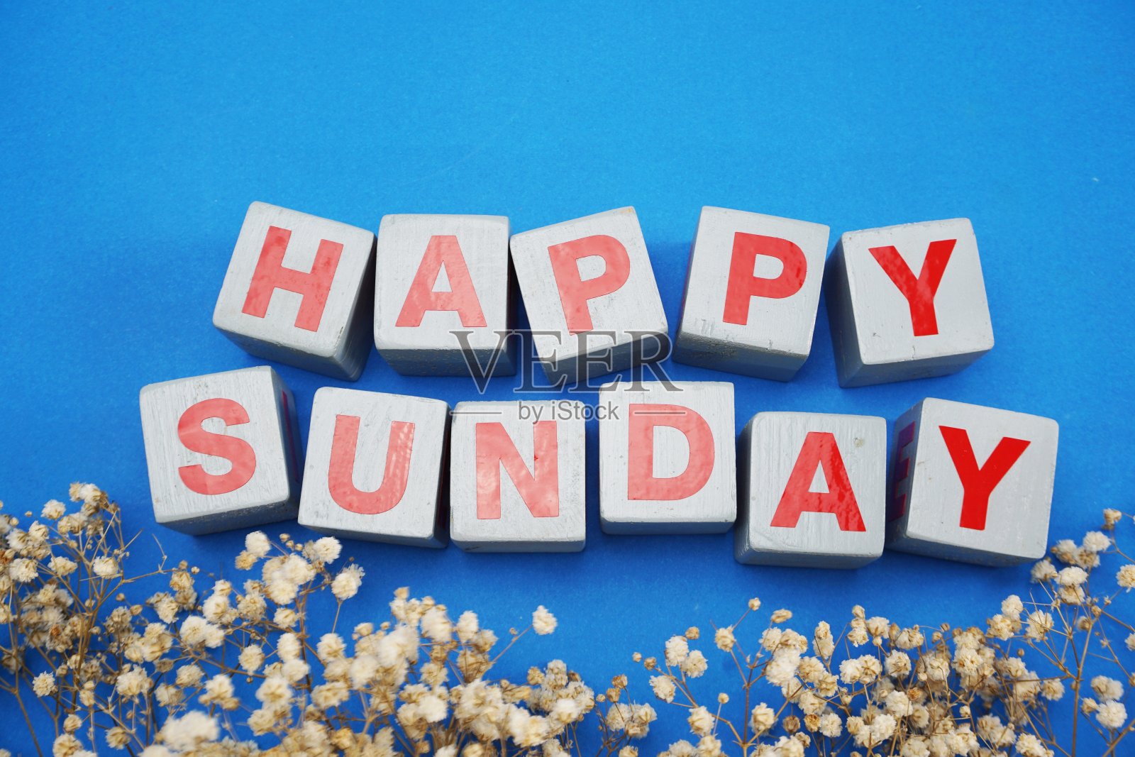 快乐的星期天俯视图与干花在蓝色的背景照片摄影图片