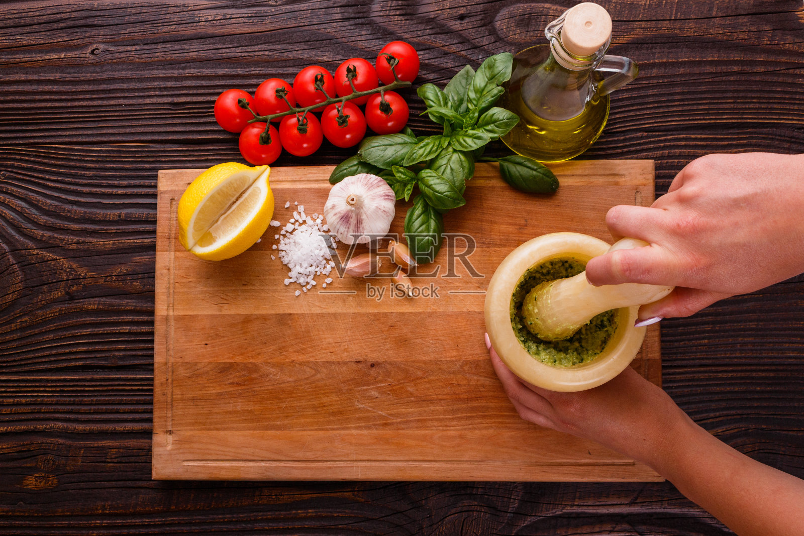 一个年轻女子在研钵里准备香蒜沙司照片摄影图片