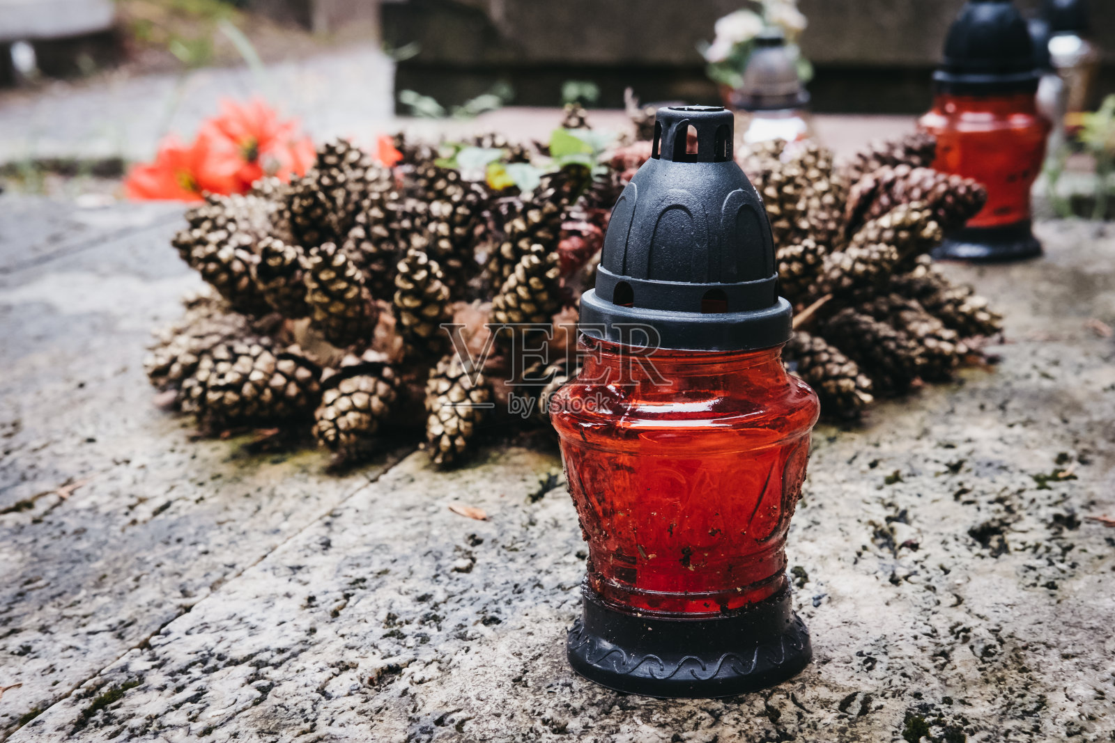 欧洲公墓的松果花环和墓碑上的蜡烛。照片摄影图片