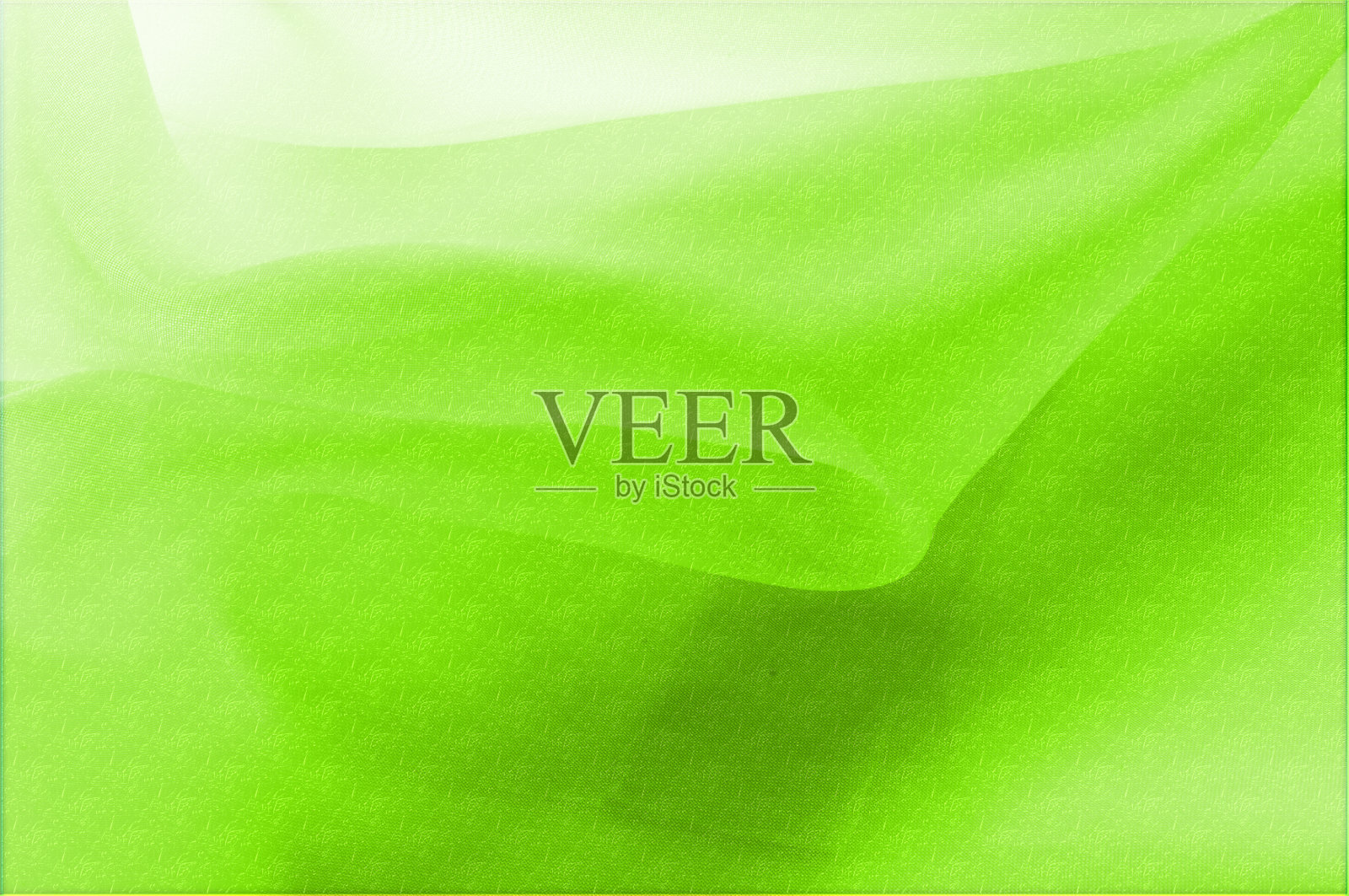 质地、背景、模式。丝织品是透明的，绿色的。抽象柔软的雪纺纹理背景。柔软的白色雪纺曲线和波浪照片摄影图片