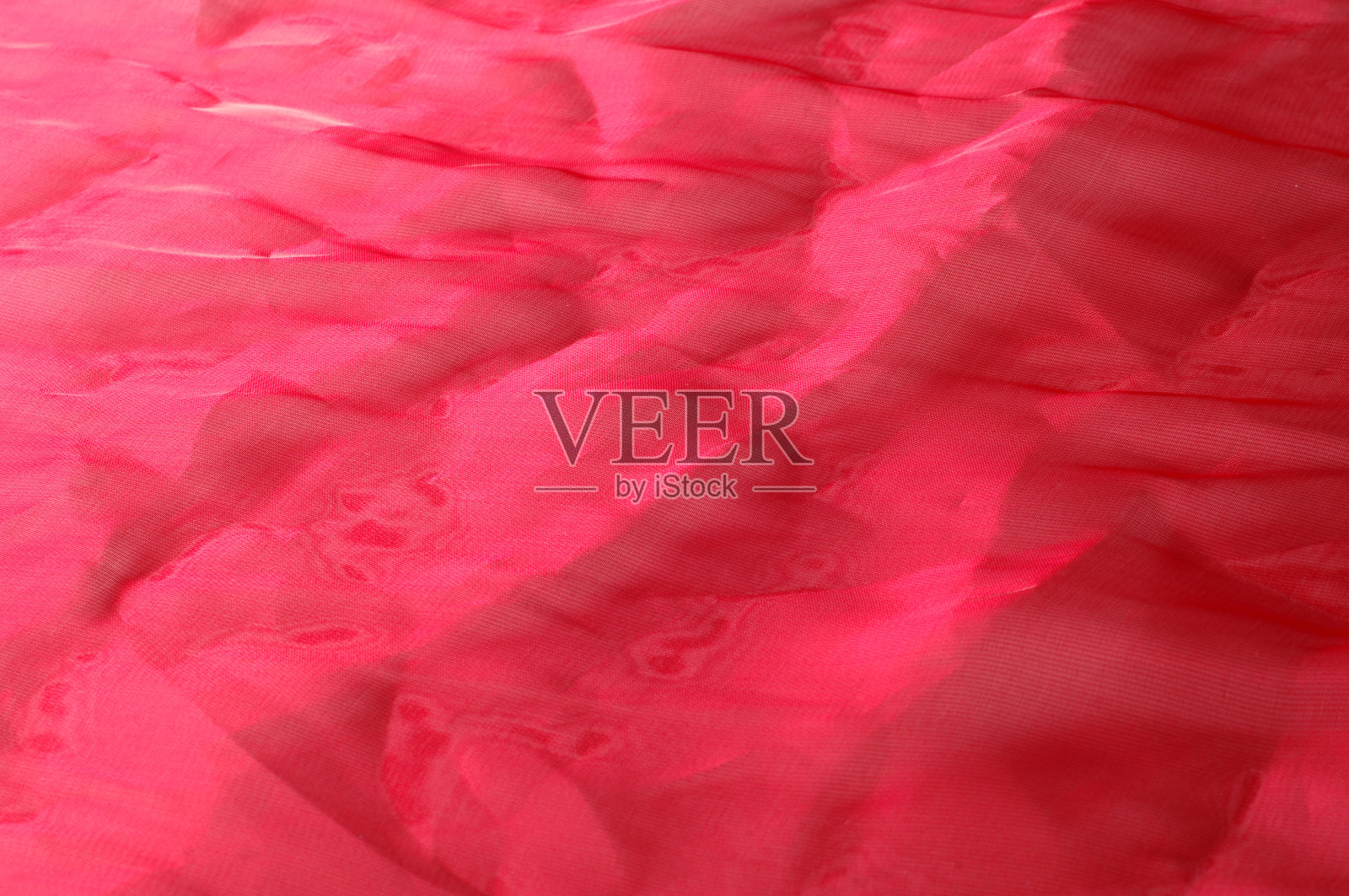 质地、背景、模式。红丝透明布布质地。这是一种有弹性的薄纱，非常适合做需要透明和给予的裙子或服装。照片摄影图片