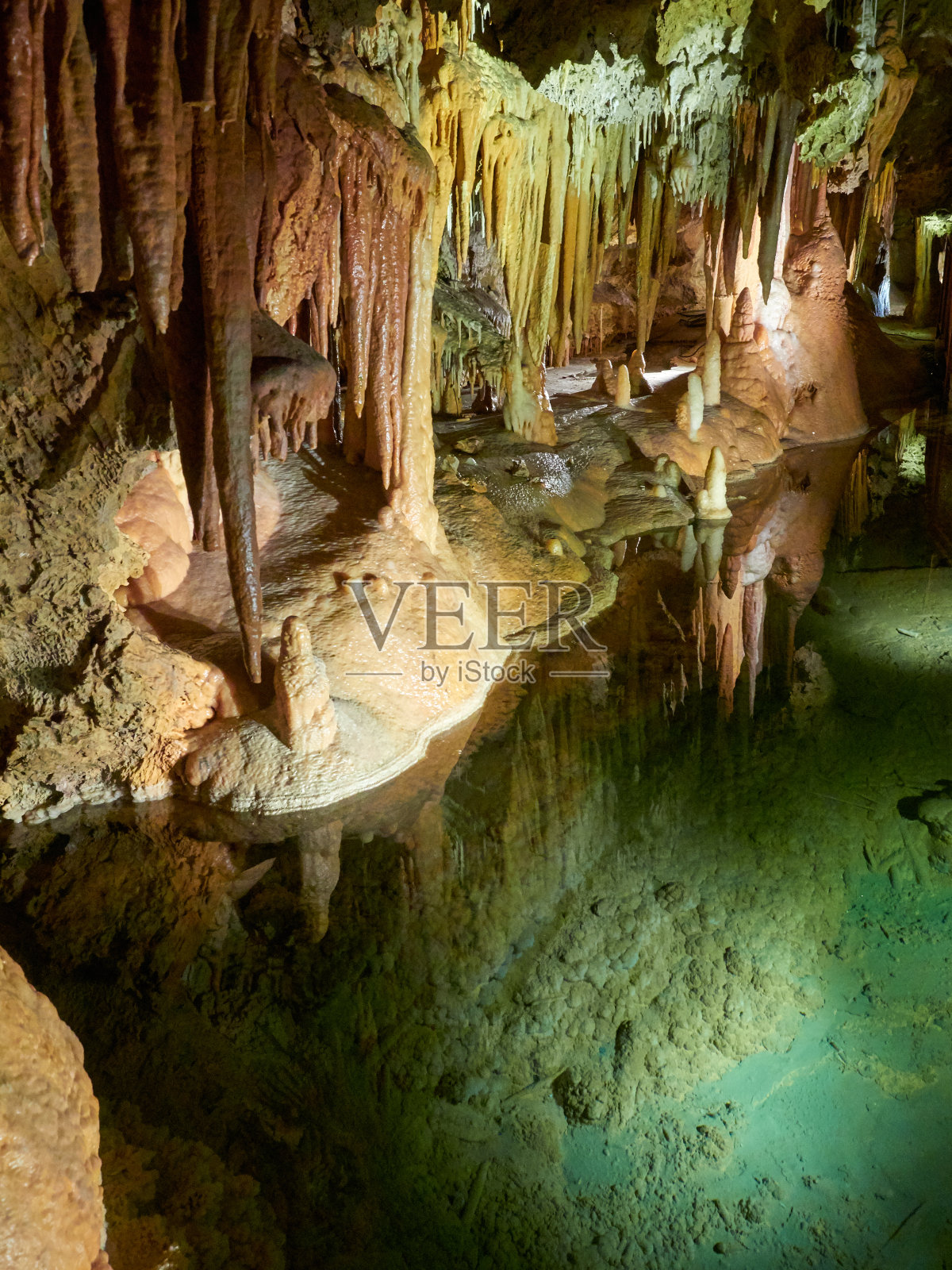 法国丰特拉比乌斯洞穴中钟乳石、石笋和石柱的形成，下面有一个小湖照片摄影图片