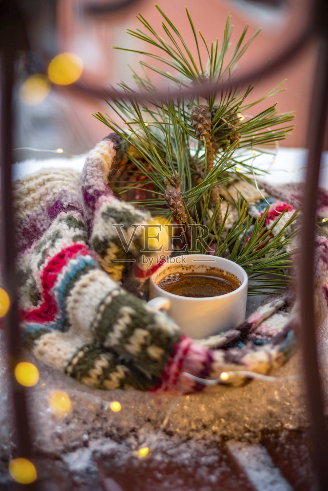 圣诞贺卡。一根带松果的云杉枝，一条围巾，一杯雪中的咖啡照片摄影图片
