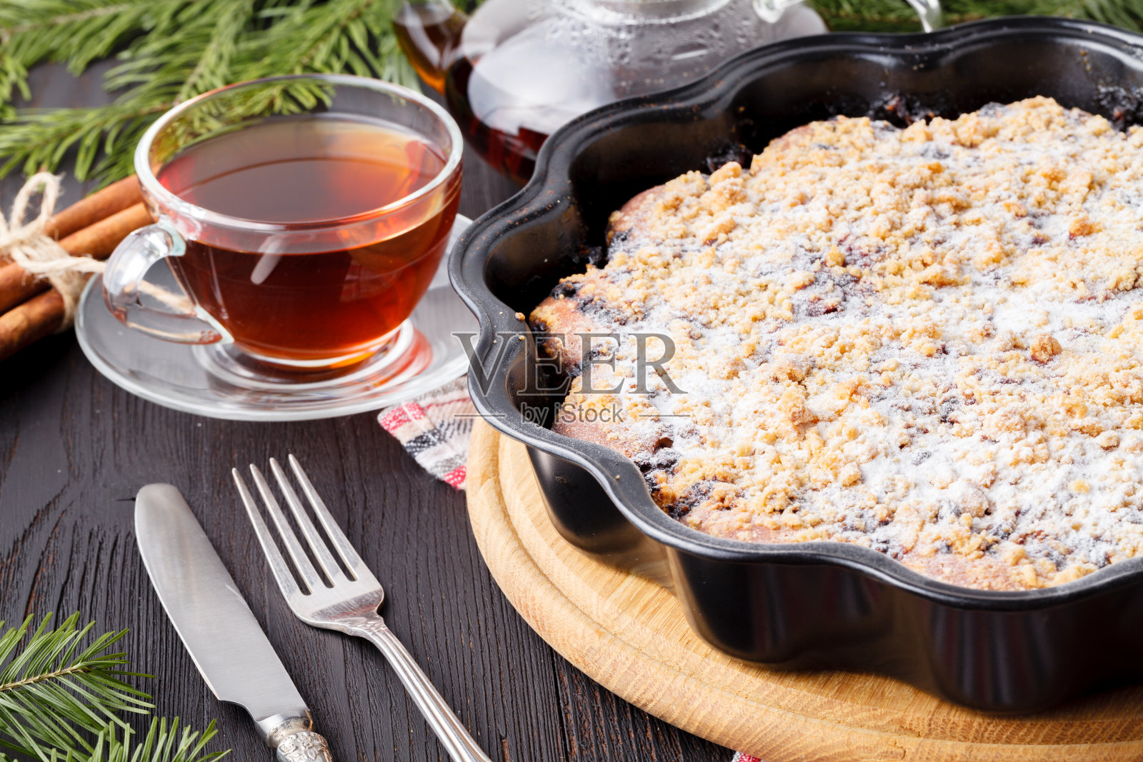 传统自制巧克力圣诞蛋糕撒糖粉，新年圣诞树装饰用雪照片摄影图片