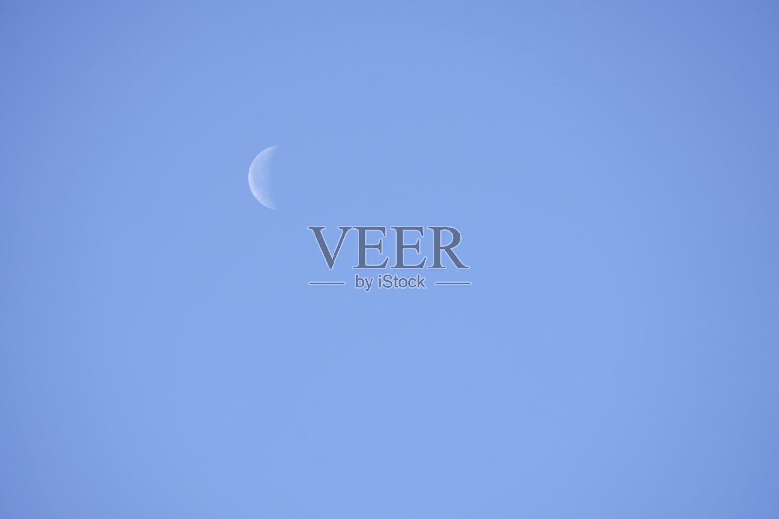 新月会减弱。月相，白天皓月当空。照片摄影图片