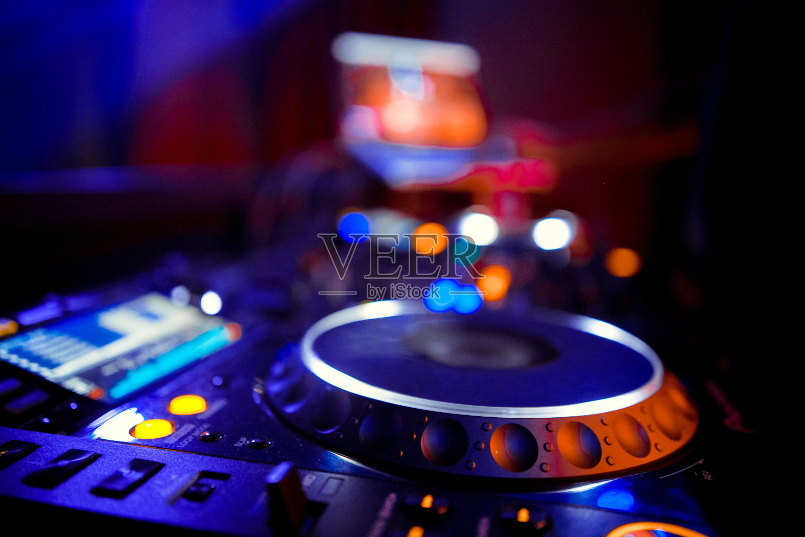Disc Jockey混音甲板和唱机在晚上与色彩斑斓的照明控制为聚会或迪斯科混音音乐照片摄影图片
