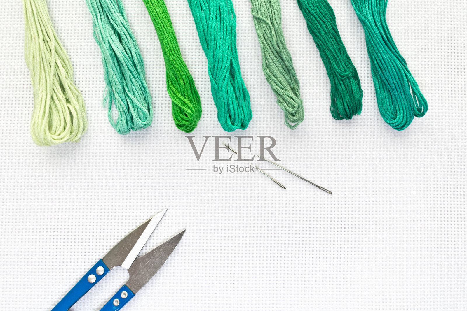 平铺顶视图与刺绣帆布，针，线在绿色照片摄影图片