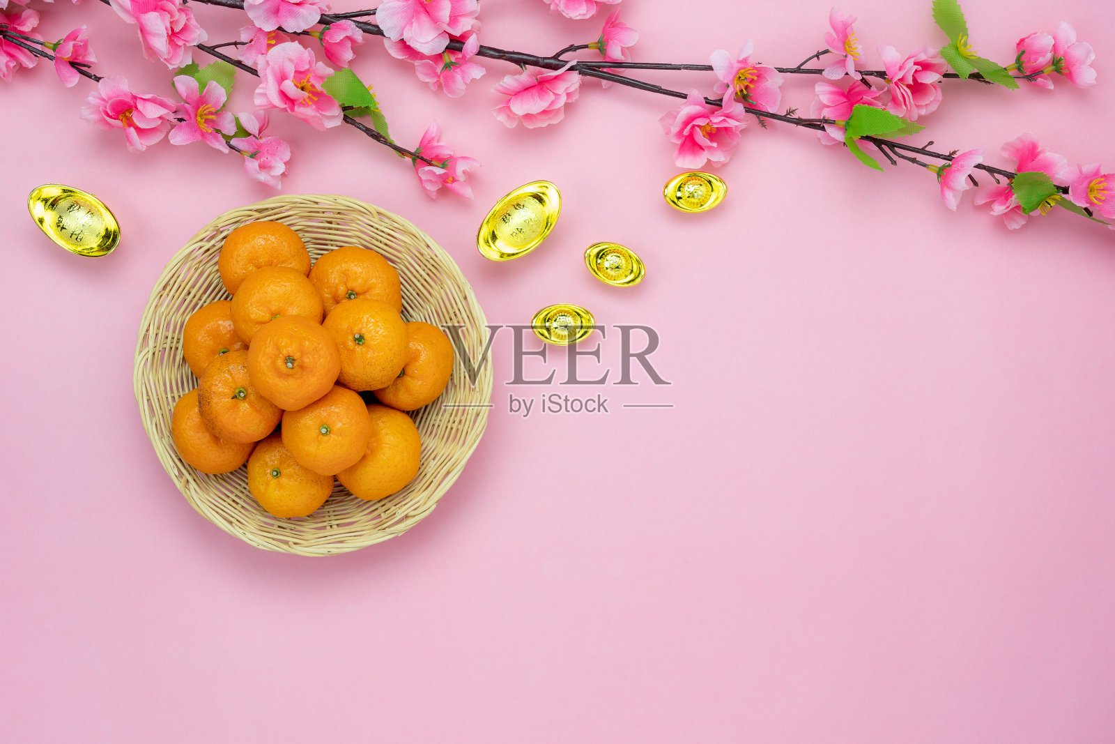 汉语的意思是富有或富有和幸福。桌面视图农历新年和中国新年假期的概念背景。扁平lay花和黄金钱和橙色在粉红色的纸和拷贝空间。照片摄影图片