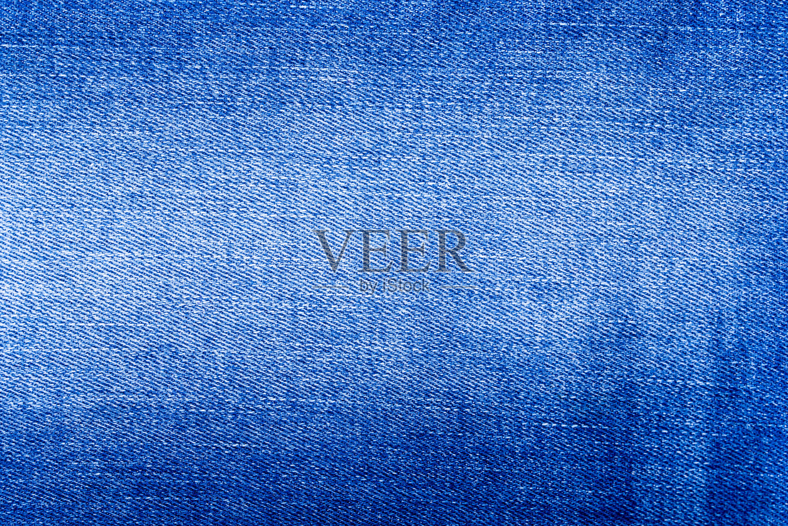 牛仔裤质地。牛仔背景纹理设计。帆布牛仔质地。可以用作背景的蓝色牛仔布。照片摄影图片