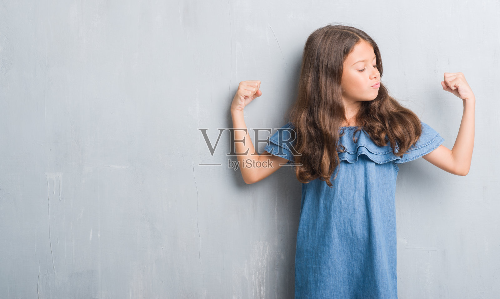 年轻的西班牙裔孩子越过垃圾灰墙惊讶地用手顶着错误，记得错误。忘记，糟糕的记忆概念。照片摄影图片