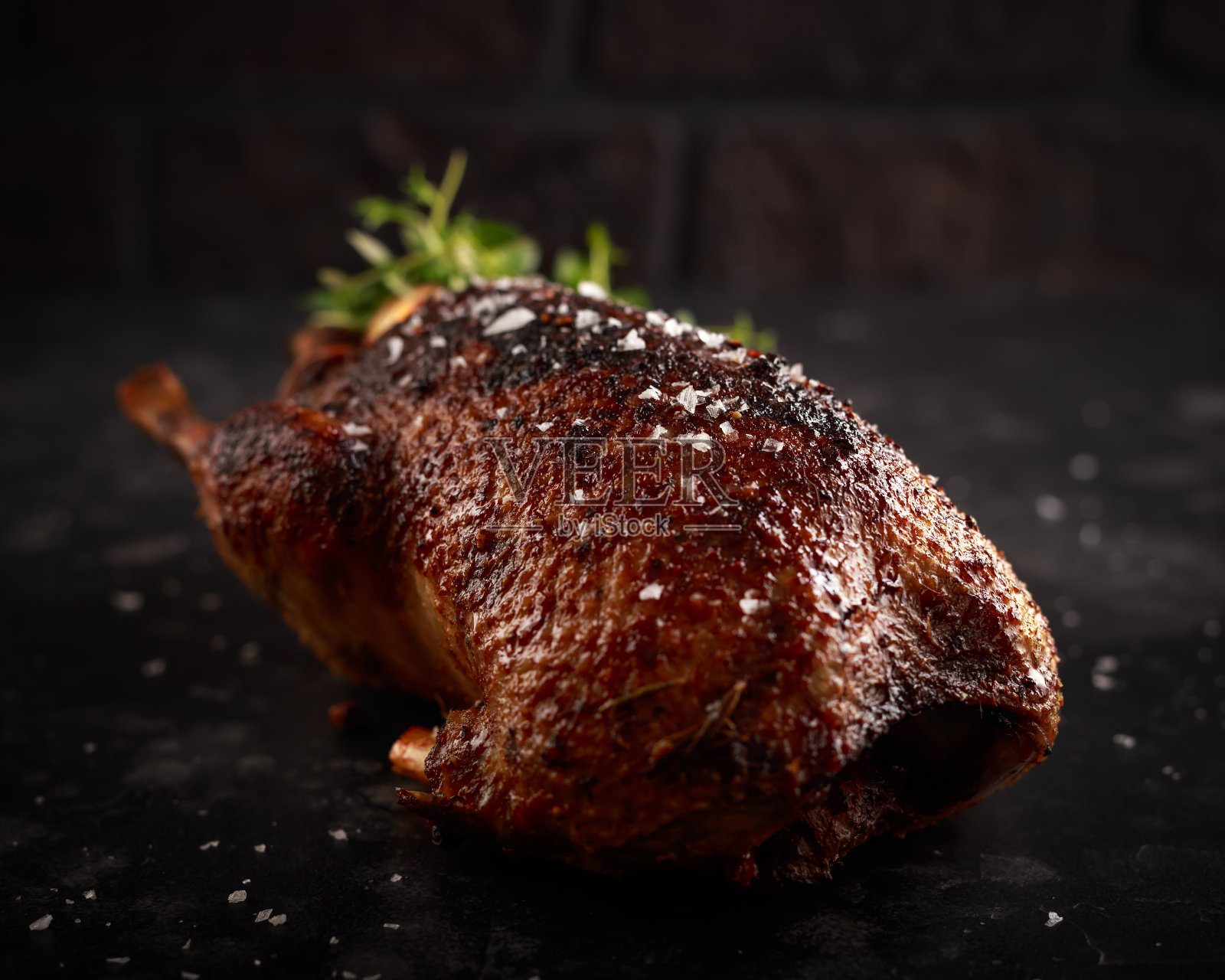 烤野鸭配橙汁和香草。照片摄影图片