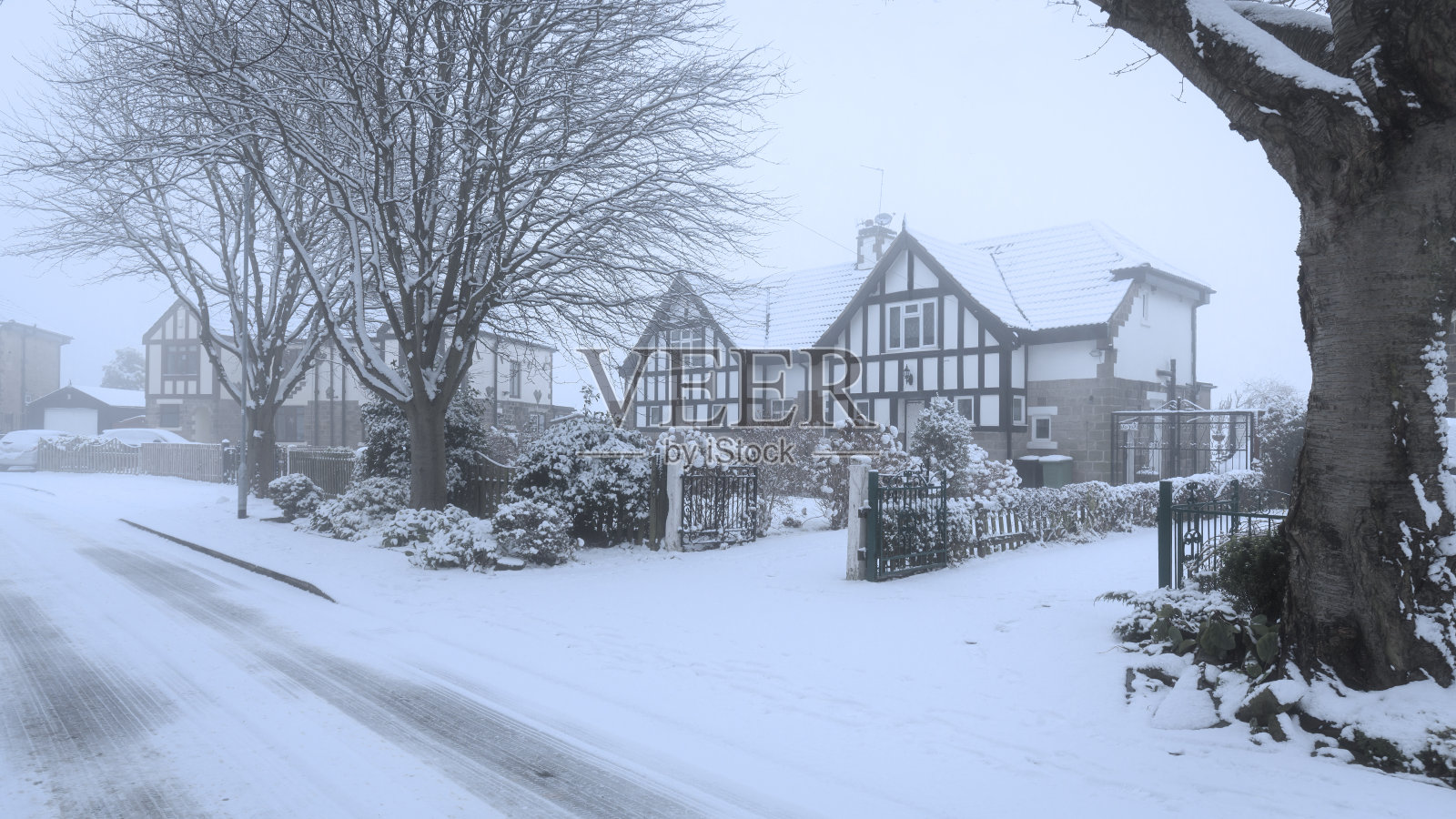 冬天，英国下雪的半独立式房屋街道照片摄影图片