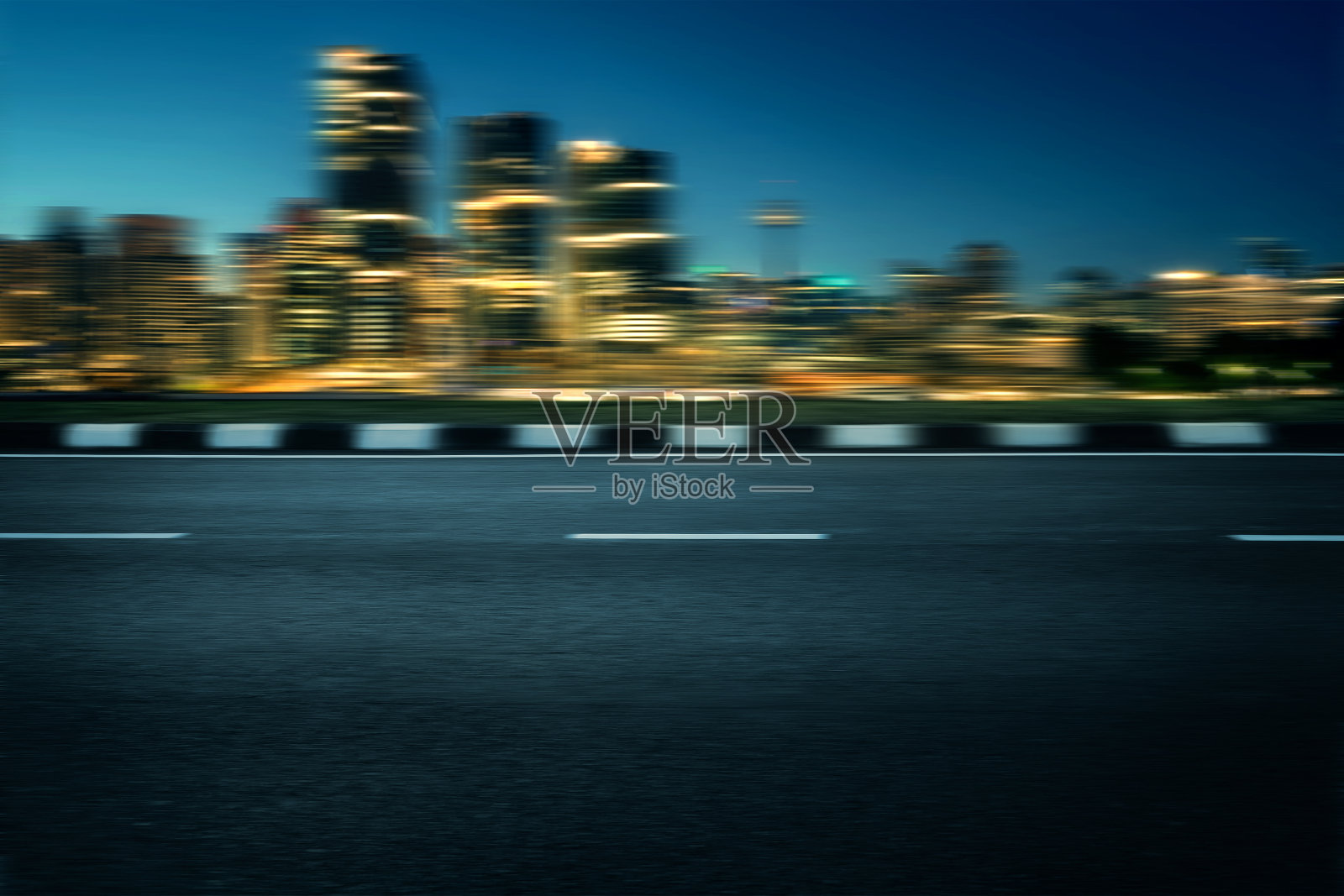 运动模糊了柏油路与现代通用的城市天际线在晚上照片摄影图片