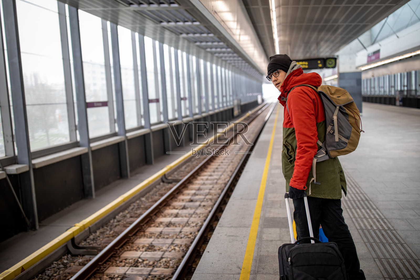背着背包在火车站等车的游客照片摄影图片
