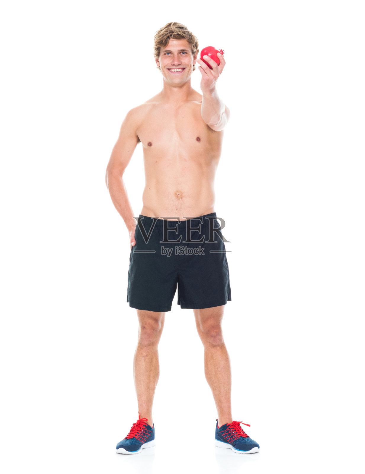 迷人的赤膊男子在运动服装持有水果照片摄影图片
