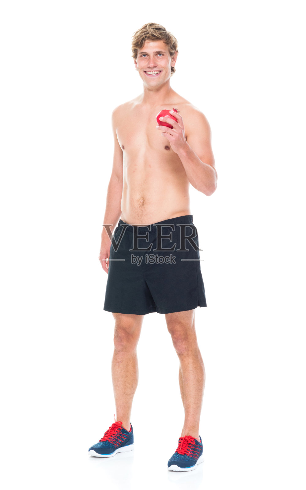 迷人的赤膊男子在运动服装持有水果照片摄影图片