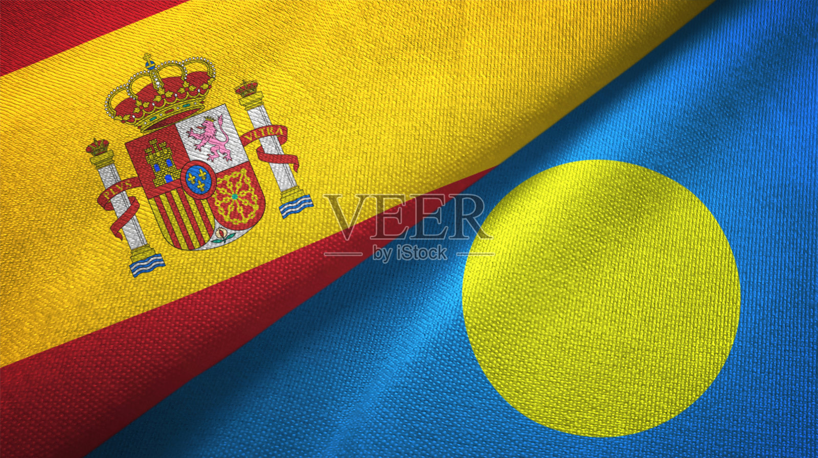 帕劳和西班牙的两面旗布交织在一起，织物质地照片摄影图片