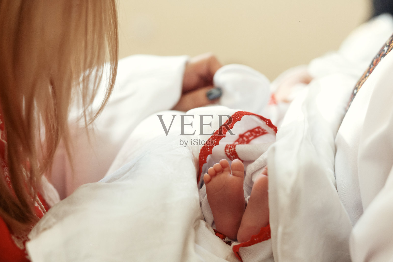 婴儿洗礼。在教堂受洗时，一个女孩可爱的小脚照片摄影图片