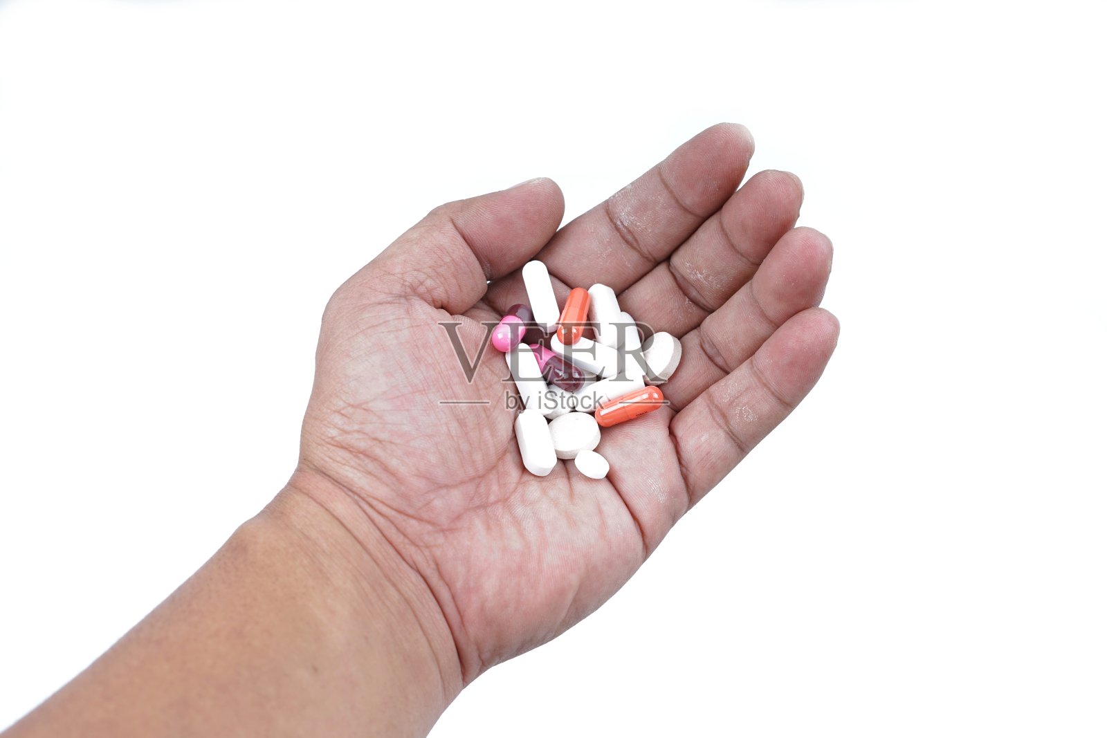 手与药丸在白色的背景照片摄影图片