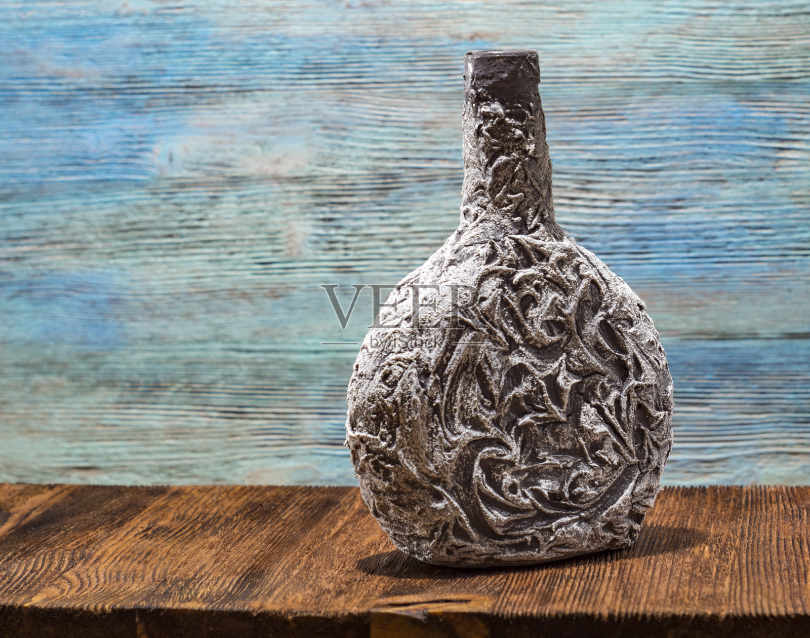 木架上有图案的瓶子，雕花的照片摄影图片