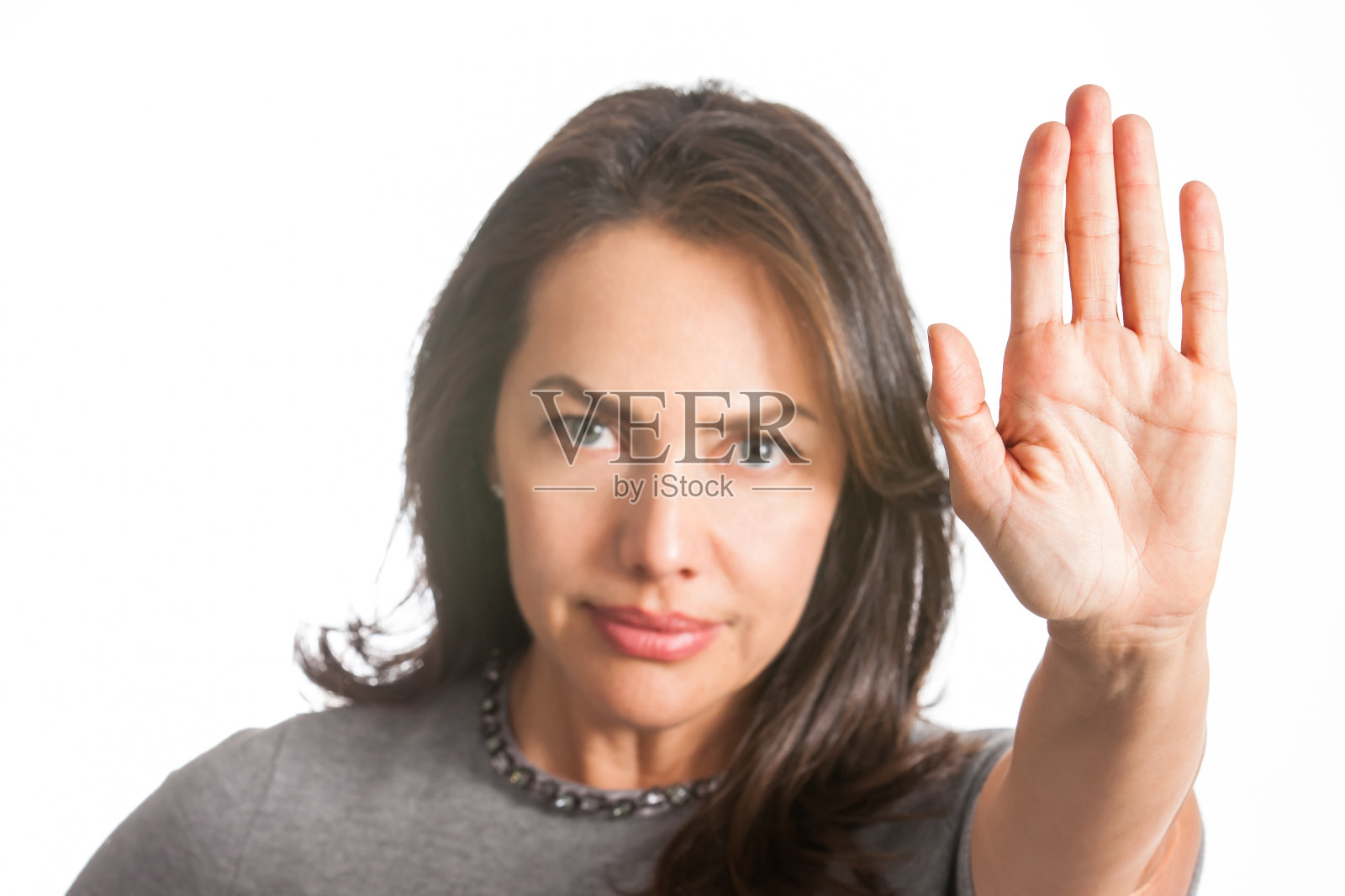 在白色的背景上，一个女人伸出手示意停止照片摄影图片