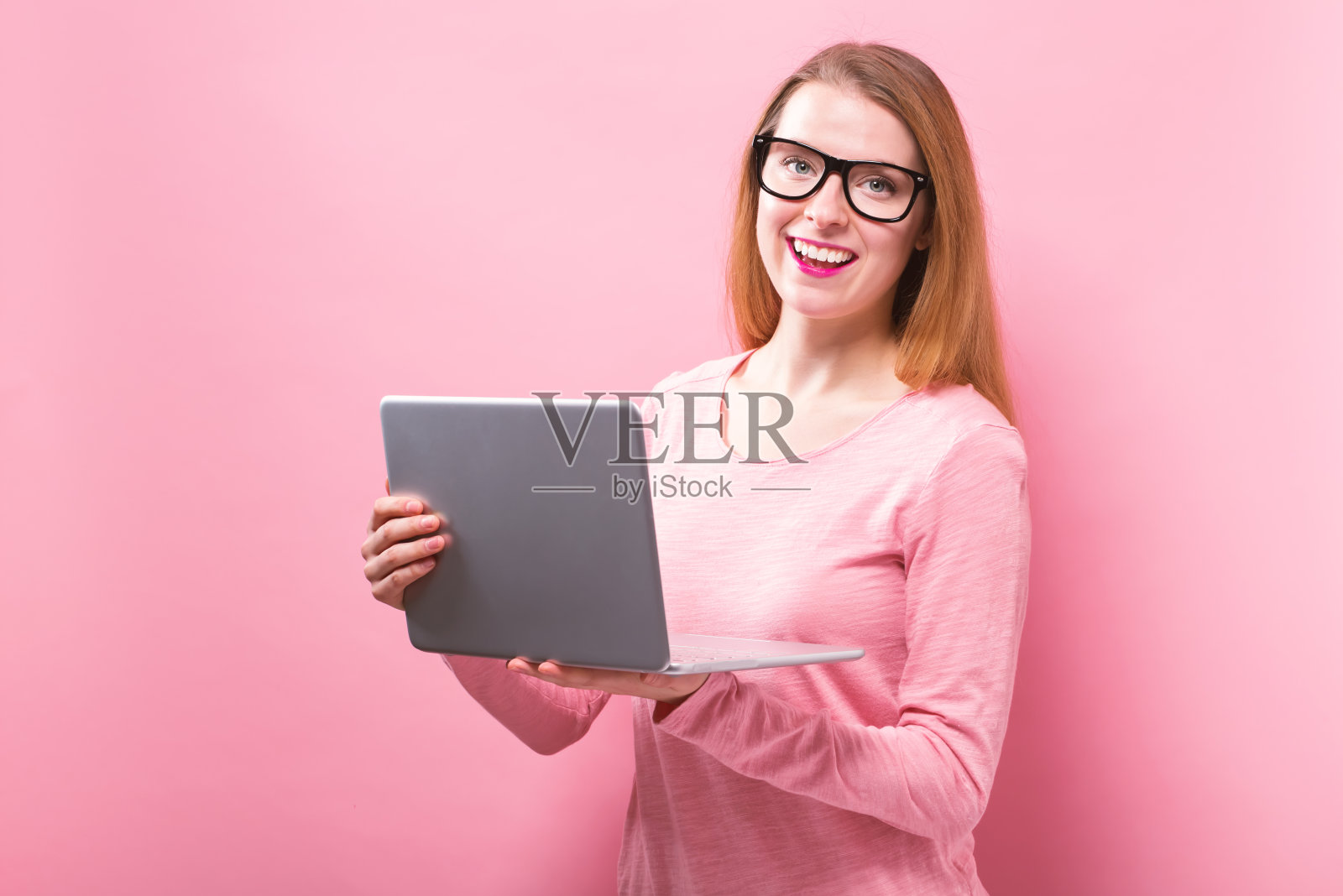 年轻女子在用她的笔记本电脑照片摄影图片