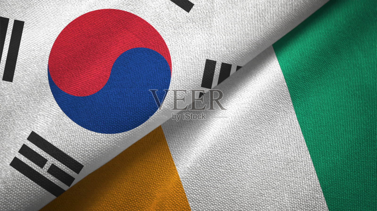 科特迪瓦和韩国象牙海岸两面旗布交织在一起，织物质地照片摄影图片