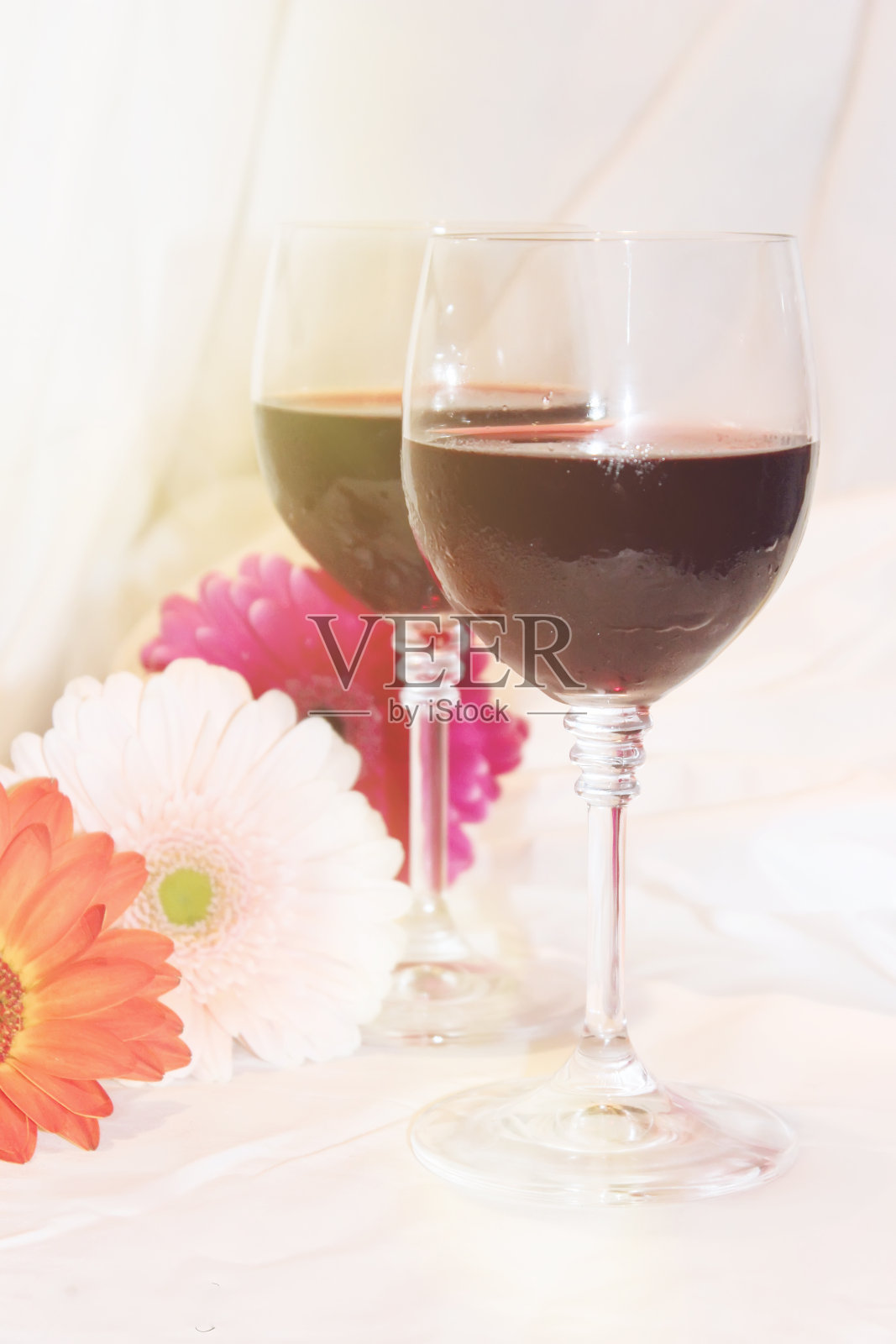 酒杯里的红酒和鲜花。有选择性的重点。照片摄影图片