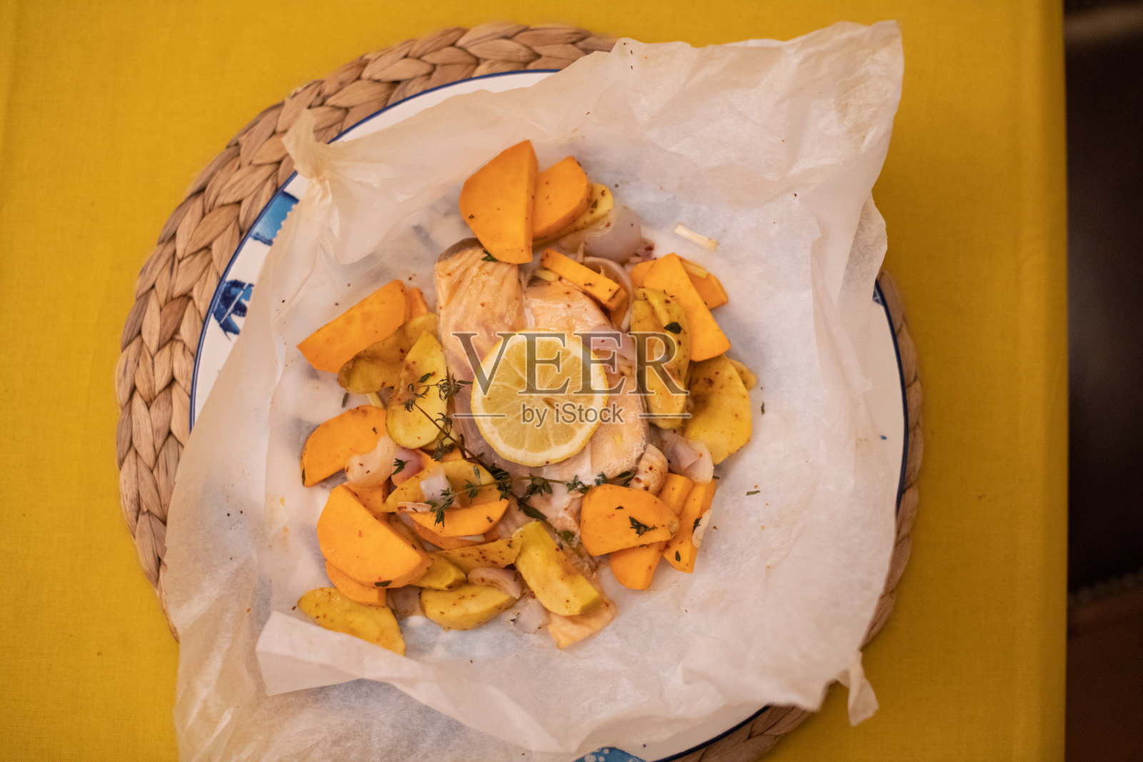 纸袋里烤鲑鱼，还有苹果、甜土豆和洋葱照片摄影图片