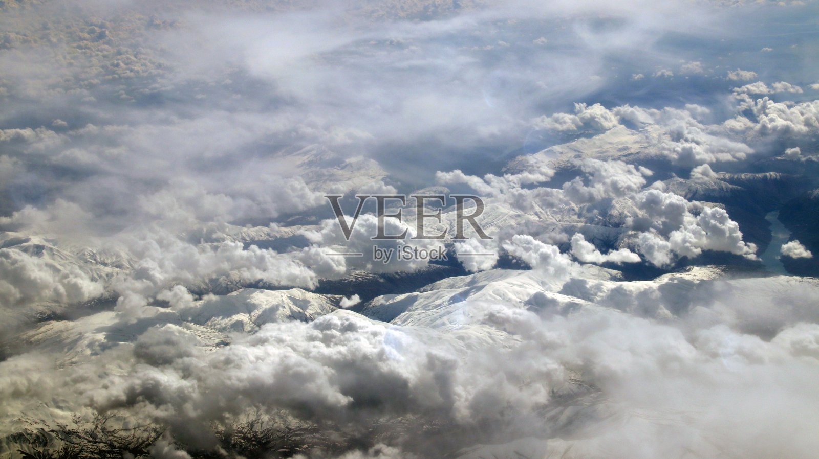 飞机舷窗视角，云海山峦，蔚蓝天空海洋照片摄影图片