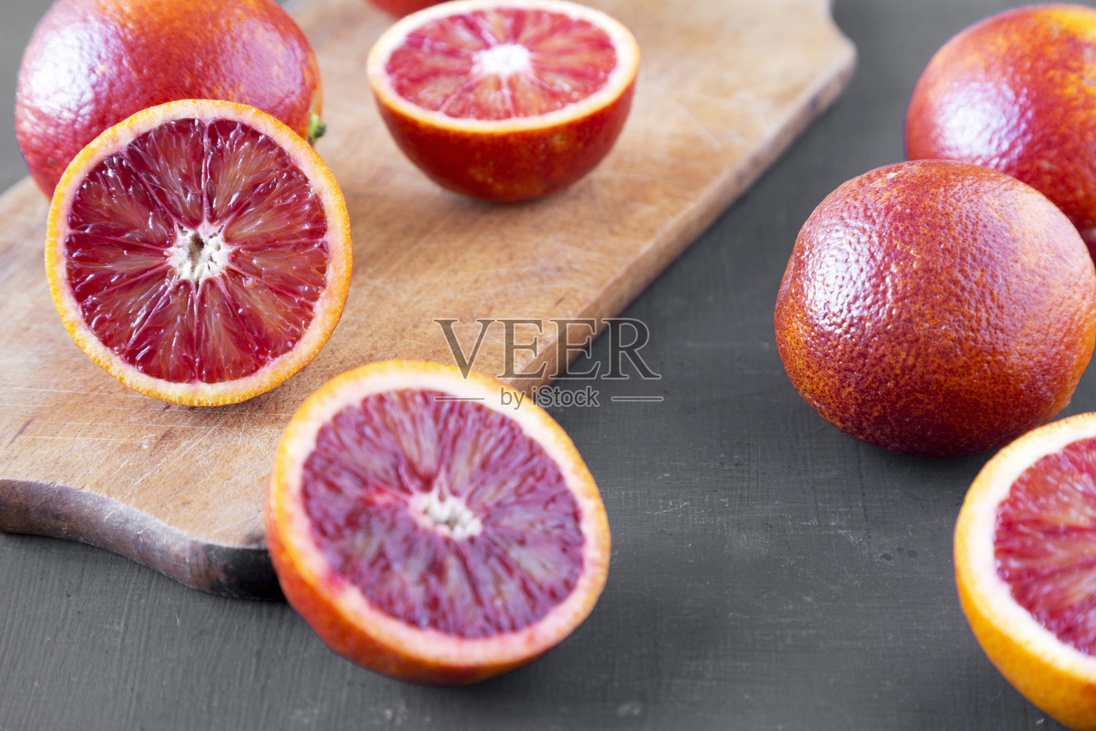 整个和减半的血橙在黑色背景，低角度视图。特写镜头。照片摄影图片