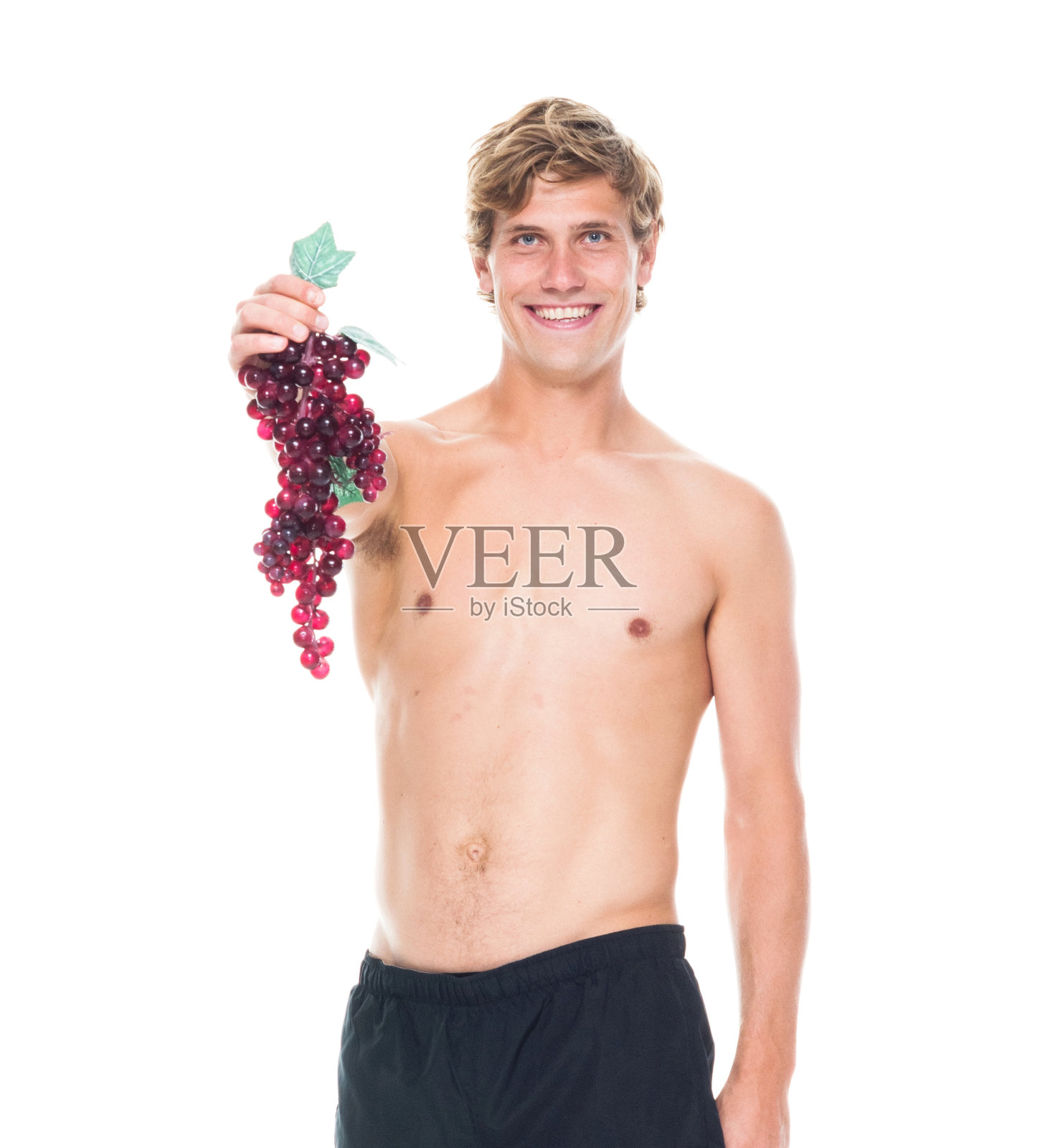 迷人的赤膊男子在运动服装持有水果照片摄影图片